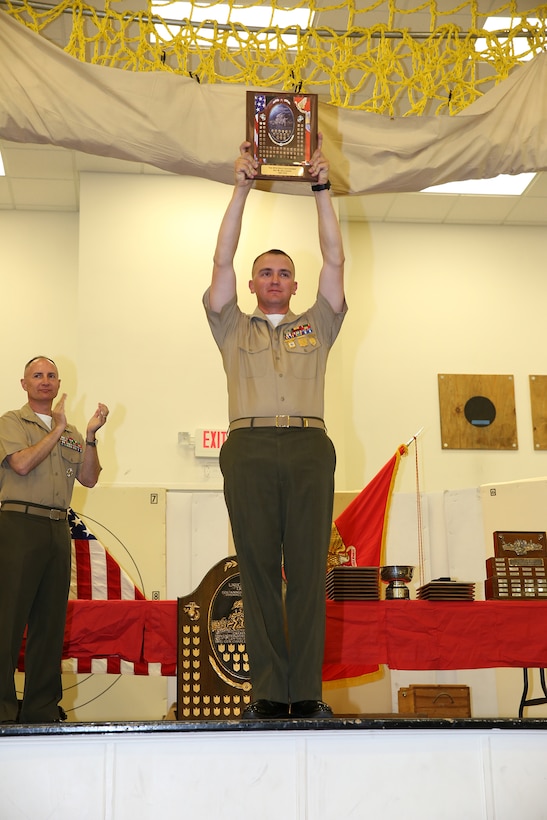Sgt. Wayne S. Gallagher, Western Division Team, receives the Lauchheimer plaque during the 2014 Marine Corps Match Championships Award Ceremony aboard the Weapons Training Battalion gymnasium at Stone Bay, April 18. Eighty-four competitors competed in the championships in three different categories. The individual rifle match, the individual pistol match and the team rifle and pistol match. (U.S. Marine Corps photo by Sgt. Alicia R. Leaders)