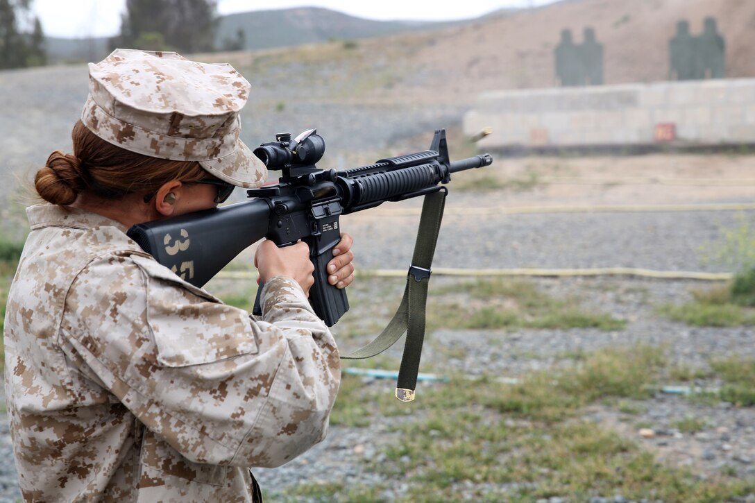 MARINE CORPS AIR STATION MIRAMAR, Calif. — Pfc. Stephanie Burnie, a food services specialist with Headquarters and Headquarters Squadron, fires an M16 rifle during a five mile squadron hike at Carlos Hathcock Range aboard Marine Corps Air Station Miramar, Calif., April 18. The Marines participated in professional military education classes before finishing the hike.   