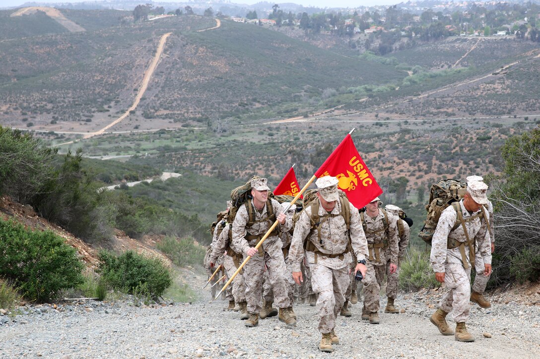 MARINE CORPS AIR STATION MIRAMAR, Calif. – Marines with Headquarters and Headquarters Squadron traverse uphill during a five mile hike aboard Marine Corps Air Station Miramar, Calif., April 18. The Marines participated in professional military education classes and fired M4 shotguns and M16 rifles at Carlos Hathcock Range.  