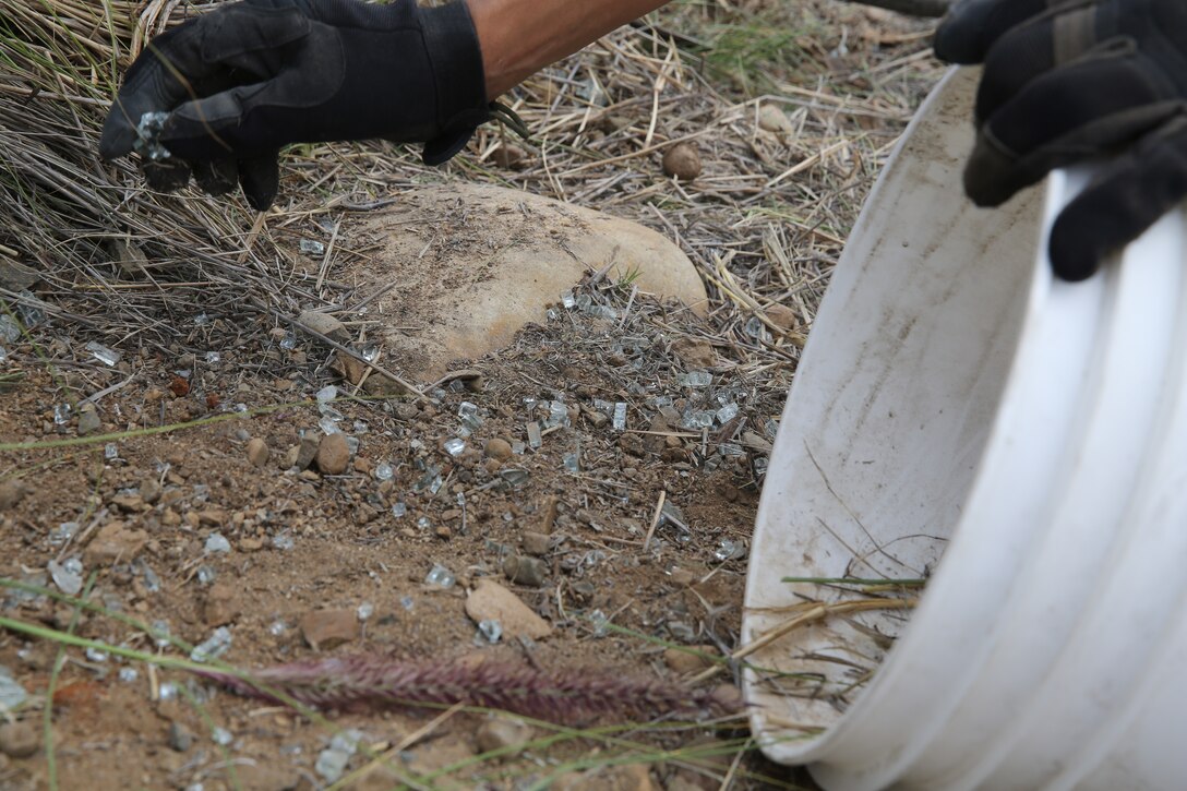 A volunteer with 3rd Marine Aircraft Wing picks up shards of glass for Earth Day near Marine Corps Air Station Miramar, Calif., April 22. Keeping the environment clean prevents contamination from seeping into the soil, potentially ruining resources for future generations. 