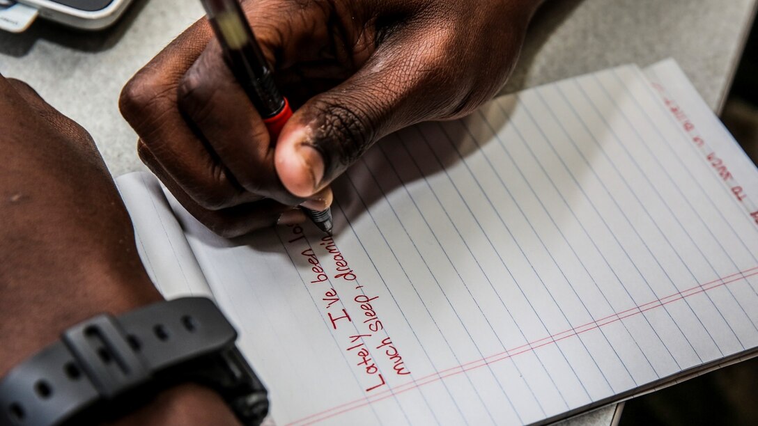 Private First Class D’Vonte Robinson, administrative specialist, 15th Marine Expeditionary Unit, takes a break from work to write down lyrics stuck in his head aboard Camp Pendleton, Calif., April 13, 2014. Robinson, 18, is from Montgomery, Ala.