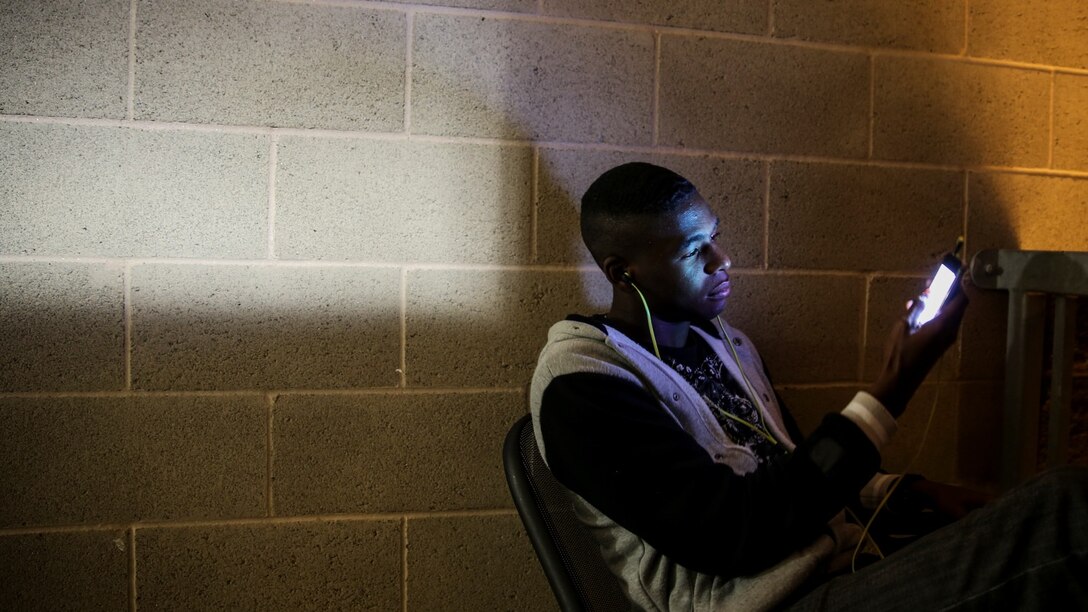 Private First Class D’Vonte Robinson, administrative specialist, 15th Marine Expeditionary Unit, relaxes after work by listening to music aboard Camp Pendleton, Calif., April 13, 2014. Robinson, 18, is from Montgomery, Ala.
