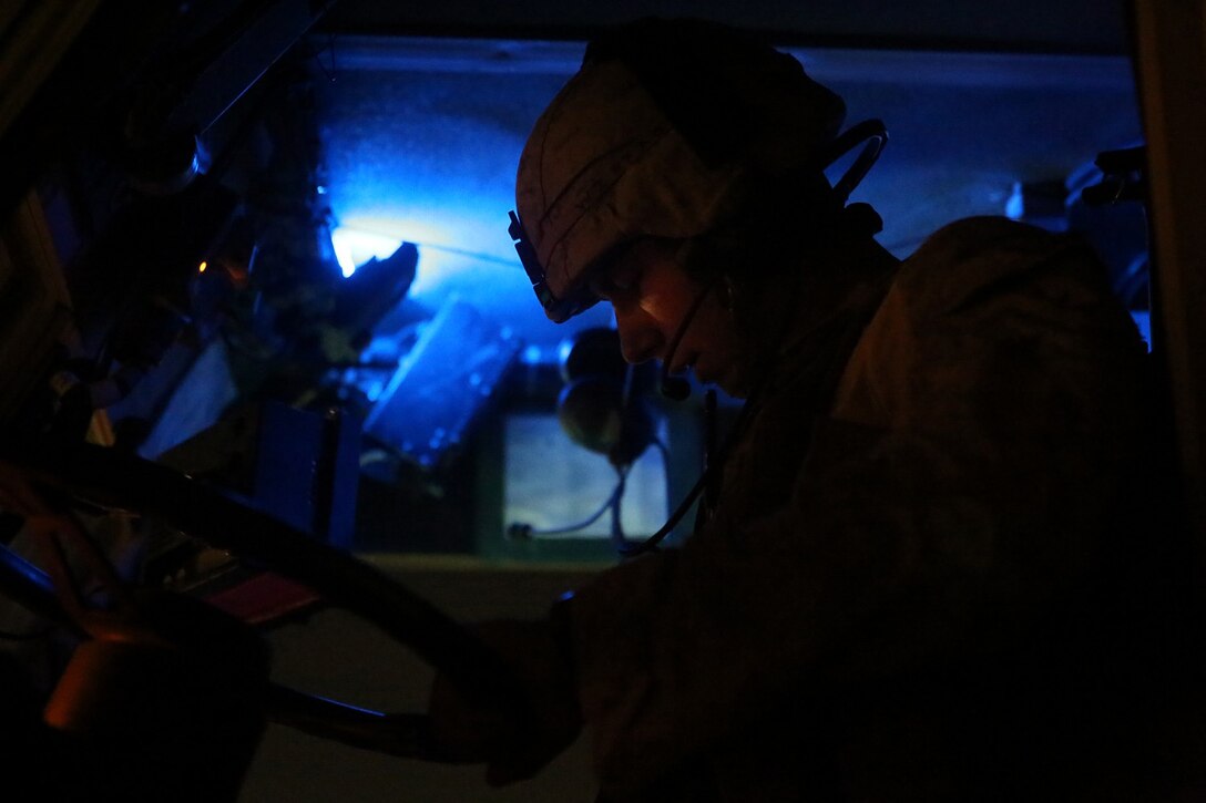 Lance Cpl. Luke Zuanich, Mine-Resistant Ambush-Protected vehicle driver, Weapons Company, 1st Battalion, 7th Marine Regiment, and a native of Clark County, Wash., checks his gear prior to a mission in Helmand province, Afghanistan, April 17. The company's two-day mission was to disrupt lethal enemy aid and to search three compounds of interest in an area suspected of Taliban influence. The compounds were suspected to contain a homemade-explosive lab, a cache for narcotics and be home to local Taliban leadership.