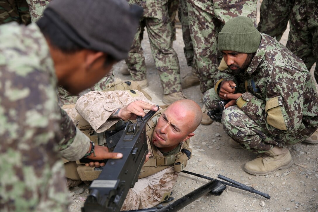 Gunnery Sgt. Gerald Furnari, platoon sergeant, Weapons Company, 1st Battalion, 7th Marine Regiment, and a native of Franklin Square, N.Y., checks the serviceability of an Afghan National Army M2 .50 caliber machine gun during a mission in Helmand province, Afghanistan, April 17. The company's two-day mission was to disrupt lethal enemy aid and to search three compounds of interest in an area suspected of Taliban influence. The compounds were suspected to contain a homemade-explosive lab, a cache for narcotics and be home to local Taliban leadership.