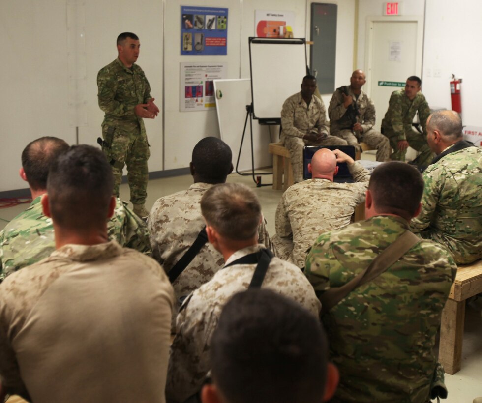 A soldier with the 31st Light Infantry Battalion from the Republic of Georgia translates for multinational forces noncommissioned officers during a Coalition Committed and Engaged Leadership Symposium aboard Camp Leatherneck, Afghanistan, April 20, 2014. The class gave NCOs the opportunity to speak about leadership within their units as well as to become familiar with their counterparts in joint services. (U.S. Marine Corps photo by Cpl. Cody Haas/ Released)