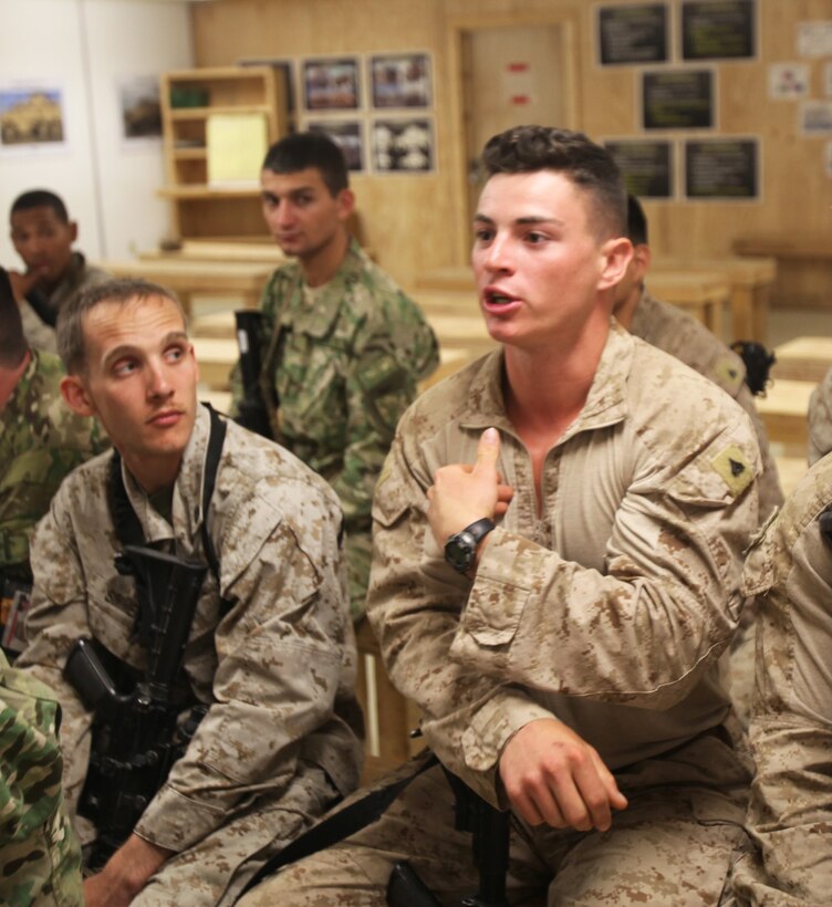 Corporal Nicholas Perrorazio, an infantry Marine with 1st Battalion, 9th Marine Regiment, speaks about noncommissioned officer leadership traits during a Coalition Committed and Engaged Leadership Symposium aboard Camp Leatherneck, Afghanistan, April 20, 2014. The class gave NCOs the opportunity to speak about leadership within their units as well as to become familiar with their counterparts in joint services. (U.S. Marine Corps photo by Cpl. Cody Haas/ Released)