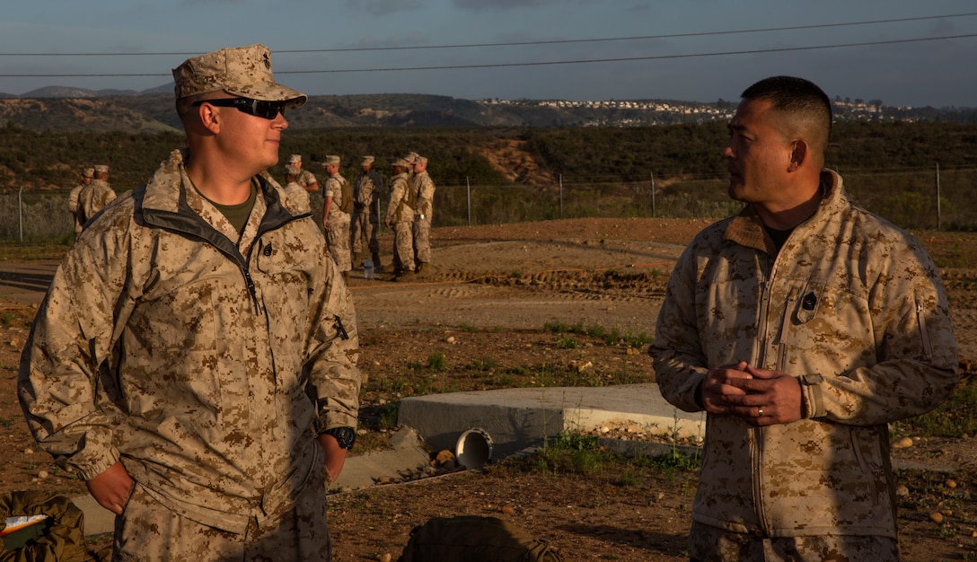 Staff Sgt. James Timmins, left, operations chief with Marine Attack Squadron 211, speaks with Master Sgt. Jose Rena, right, a symposium mentor with Marine Aviation Logistics Squadron 39, about a topic during Committed and Engaged Staff Sergeant Professional Military Education aboard Marine Corps Air Station Miramar, Calif., April 22. Participants took part in guided discussions where they could sit down with an important topic and tackle it with help from peers to better equip themselves, their Marines and the Marine Corps.