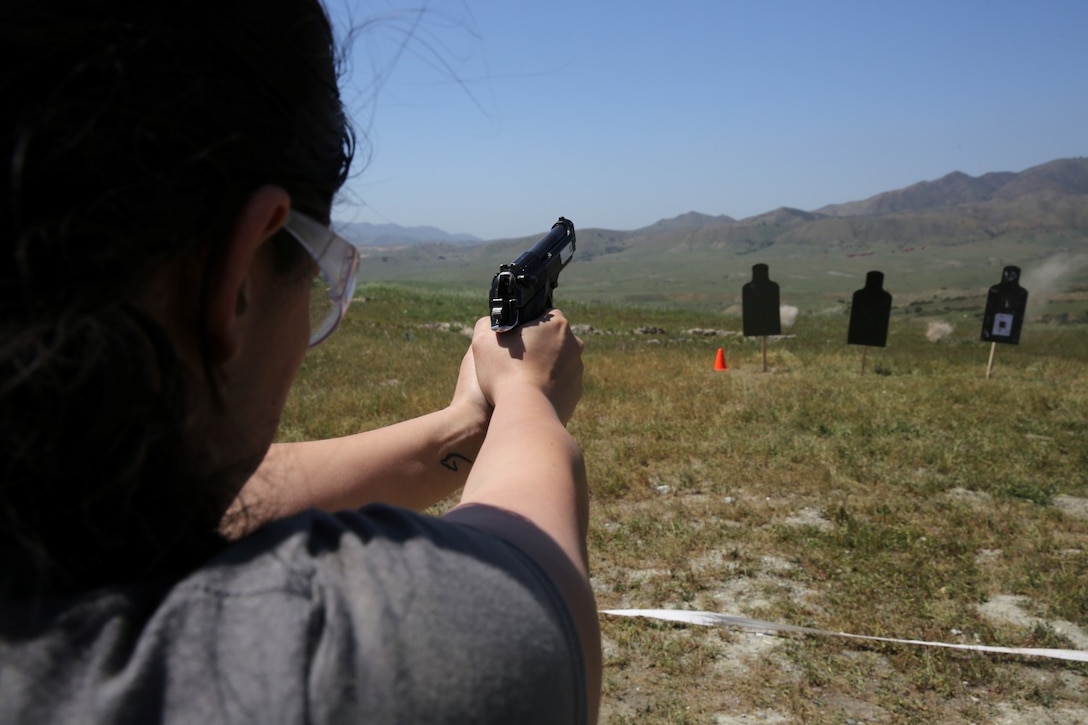 A Marine's wife fires a M9 pistol at targets on a live-fire range during a Jane Wayne Day aboard Marine Corps Base Camp Pendleton, Calif., March 16, 2014. 1st Light Armored Reconnaissance Battalion held the event to give spouses an opportunity to experience a day as a Marine. Jane Wayne Day gives the family members an inside look of how the Marines contribute to their unit and promotes a friendly environment within the battalion.