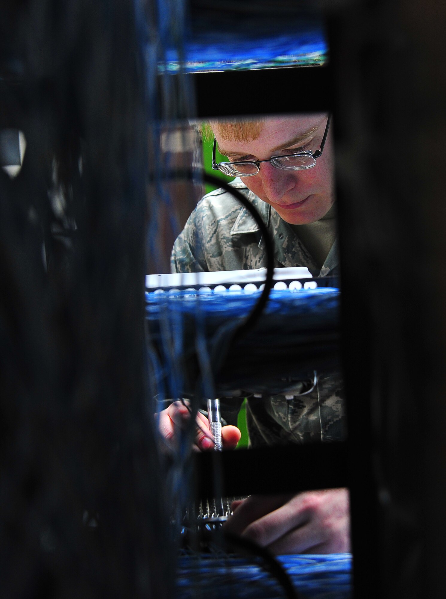 U.S. Air Force Senior Airman Matthew Clark, 35th Communications Squadron cyber transport systems journeyman, installs a phone line to the base’s phone infrastructure network at Misawa Air Base, Japan, April 22, 2014. When a new phone line is installed, the cyber transport phone team ensures the cabling for communication is established. (U.S. Air Force photo/Senior Airman Jose L. Hernandez-Domitilo)