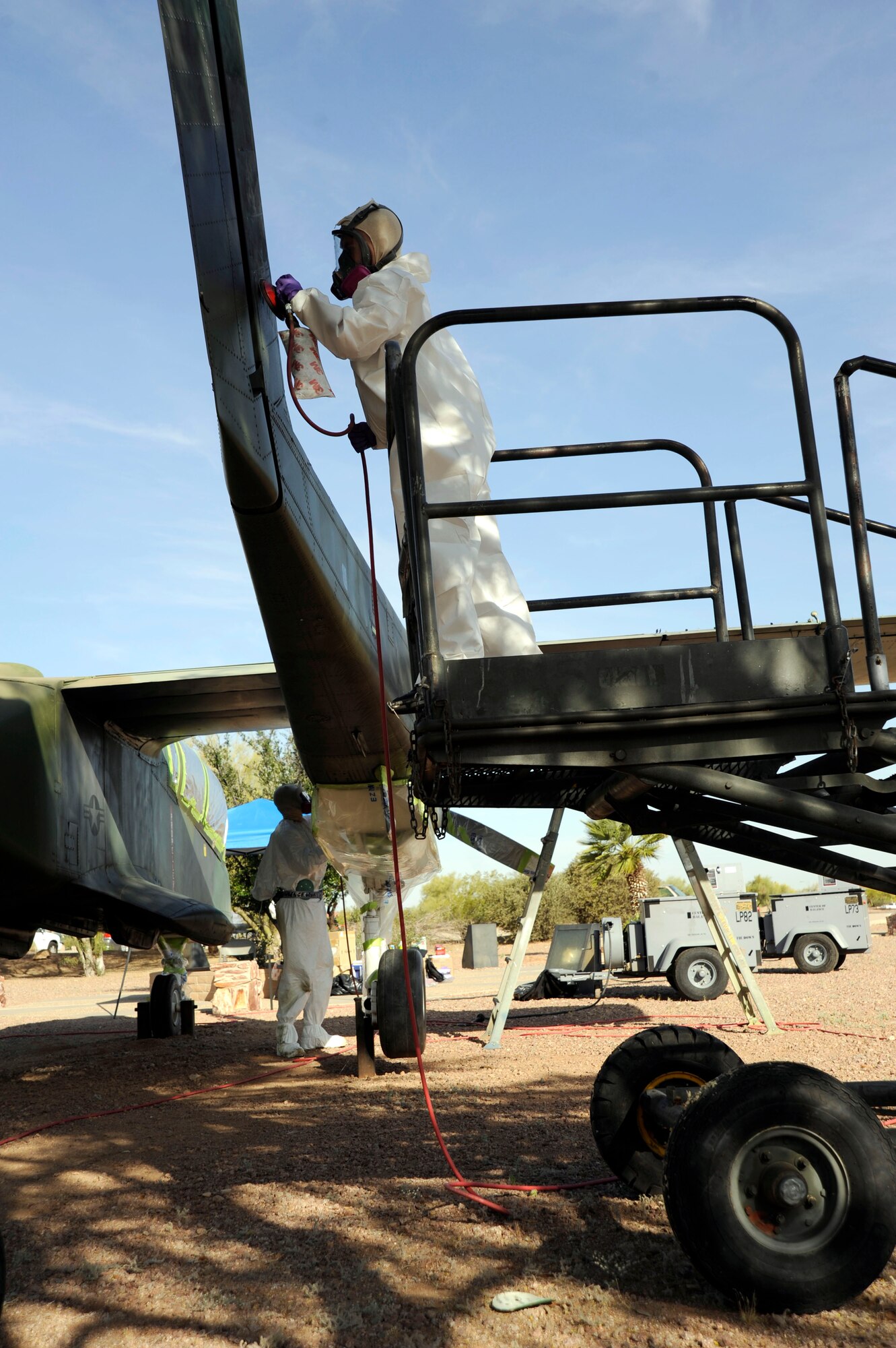 U.S. Air Force Airman 1st Class Greg Lettang, 355th Equipment Maintenance Squadron aircraft structural maintainer, strips paint off an OV-10A Bronco at Davis-Monthan Air Force Base, Ariz., April 22, 2014. Over the next few weeks maintenance and refurbishing will take place on some of the static displays located in Heritage Park. (U.S. Air Force photo by Airman 1st Class Betty R. Chevalier/released)