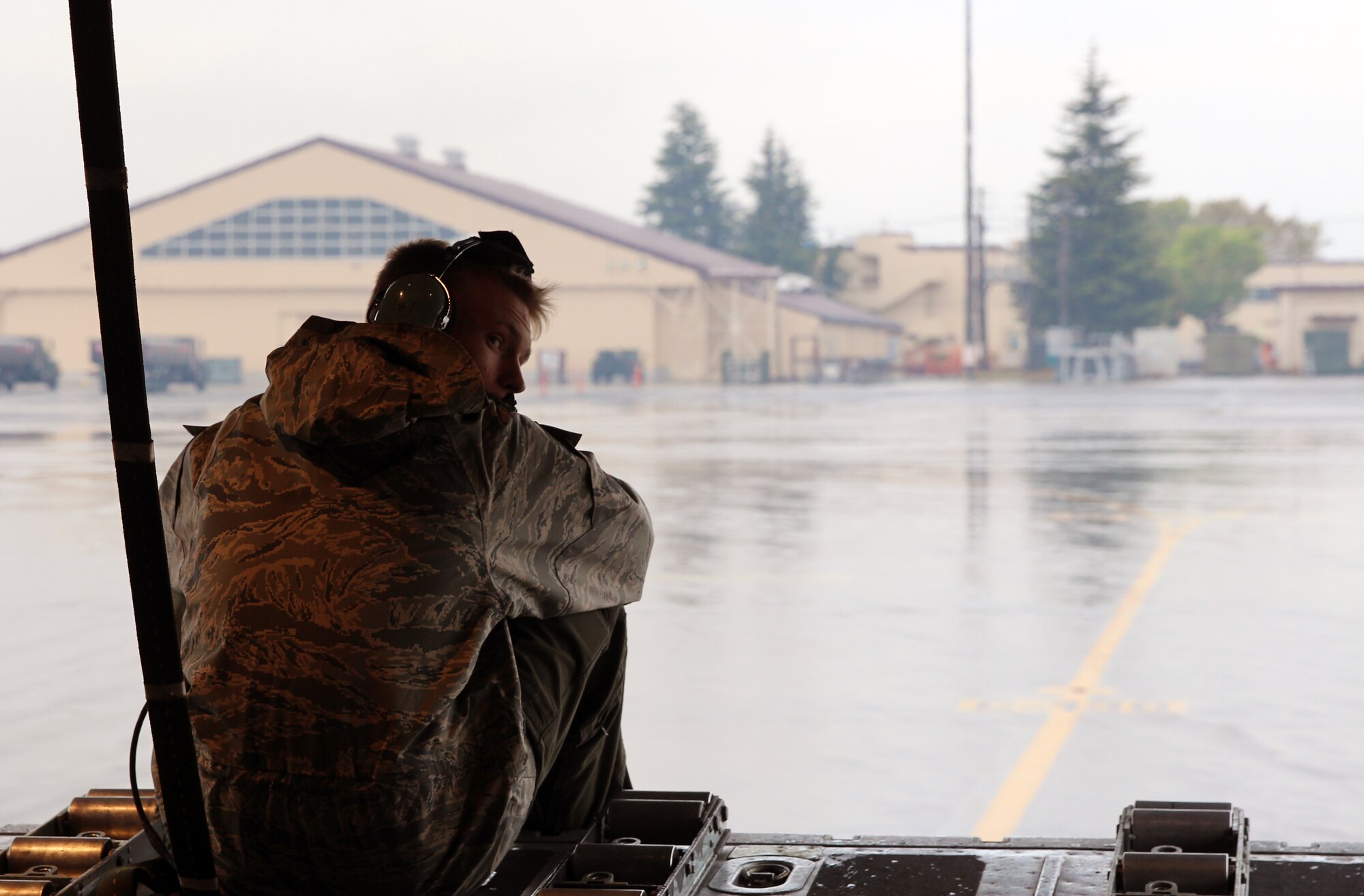 A Yokota Air Base maintainer sits at the edge of a C-130 Hercules liftgate before the aircraft launches out for Exercise Max Thunder, April 18, 2014. Max Thunder is the Air Component-led portion of Exercise Foal Eagle, a series of joint and bilateral exercises that integrate ground, air, naval, expeditionary and special operations. (U.S. Air Force photo by 2d Lt. Ashley Wright/Released)