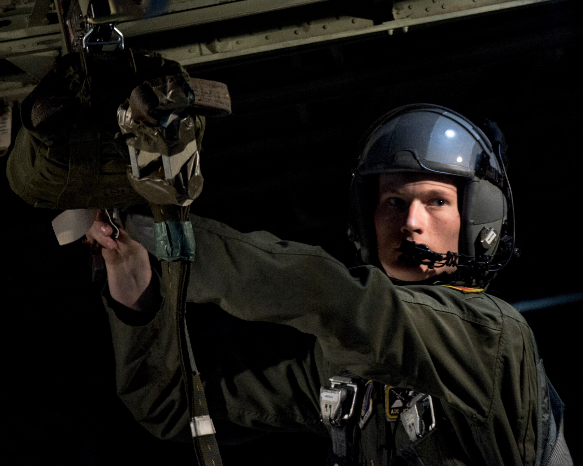 Airman 1st Class Nicholas Oswald, 36th Airlift Squadron loadmaster, prepares an extraction chute for a heavy equipment airdrop pallet over the Republic of Korea during Exercise Max Thunder, April 18, 2014. Yokota Airmen flew several airlift sorties in support of the exercise to enhance their joint and allied interoperability in a simulated regional contingency. (U.S. Air Force photo by Capt. Raymond Geoffroy/Released)