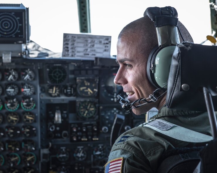Capt. Matthieu Rigollet, 36th Airlift Squadron pilot, talks to aircrew aboard a Yokota Air Base C-130H Hercules while flying to the Republic of Korea during Exercise Max Thunder, April 18, 2014. Yokota Airmen flew several airlift sorties in support of the exercise to enhance their joint and allied interoperability in a simulated regional contingency. (U.S. Air Force photo by Capt. Raymond Geoffroy/Released)