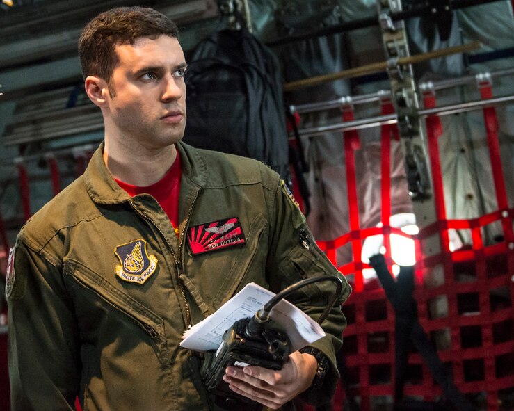 1st Lt. Ben Ortega, 36th Airlift Squadron navigator, listens to a pre-flight crew briefing aboard a Yokota Air Base C-130H Hercules at Yokota Air Base, Japan, April 18, 2014. Yokota launched multiple C-130 formation sorties throughout April in support of the Max Thunder bilateral air exercise in the Republic of Korea. (U.S. Air Force photo by Capt. Raymond Geoffroy/Released)