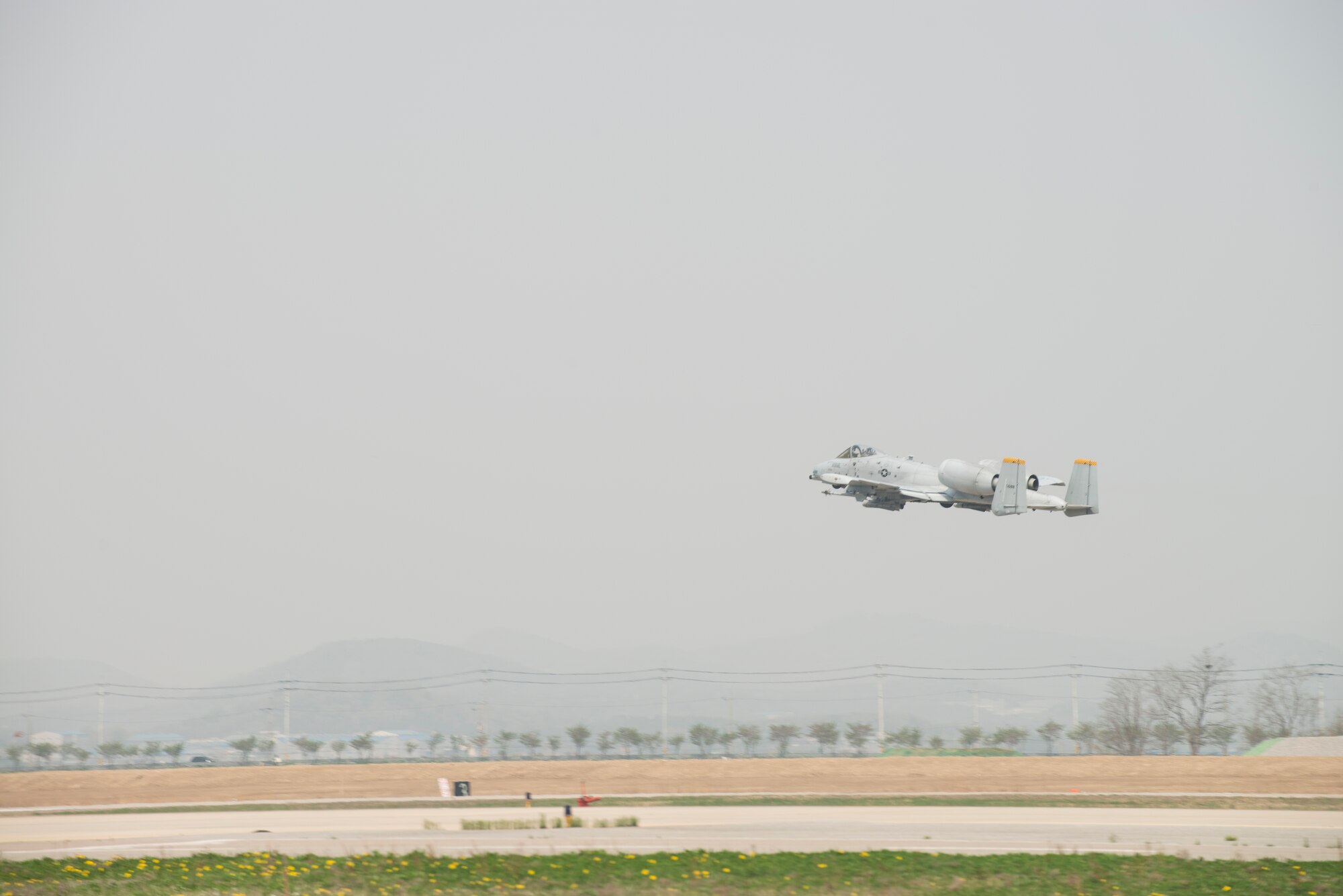 An A-10 Thunderbolt II from the 25th Fighter Squadron takes off from Osan Air Base, Republic of Korea, during an exercise sortie April 18. The 25th Fighter Squadron participated in Exercise Pacific Thunder, a combined, joint combat search and rescue exercise April 14-18. During the exercise, A-10 pilots exercised their "Sandy" role, providing cover for simulated downed pilots and escorting rescue helicopters in hostile areas. (U.S. Air Force photo by Staff Sgt. Jacob Barreiro)