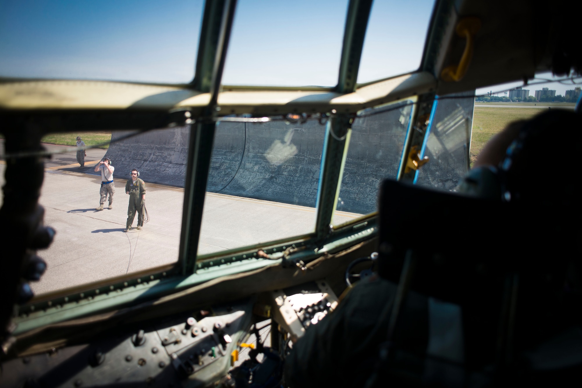 A 36th Airlift Squadron loadmaster, assists the pilot during pre-flight checks prior to taking off in a C-130 Hercules April 23, 2014 at Yokota Air Base, Japan. The sortie took off in support of Operation Max Thunder, a bilateral aerial training exercise that trains U.S. and Republic of Korea Air Force pilots to work closer together against a hostile force. (U.S. Air Force photo by Staff Sgt. Chad C. Strohmeyer/Released)