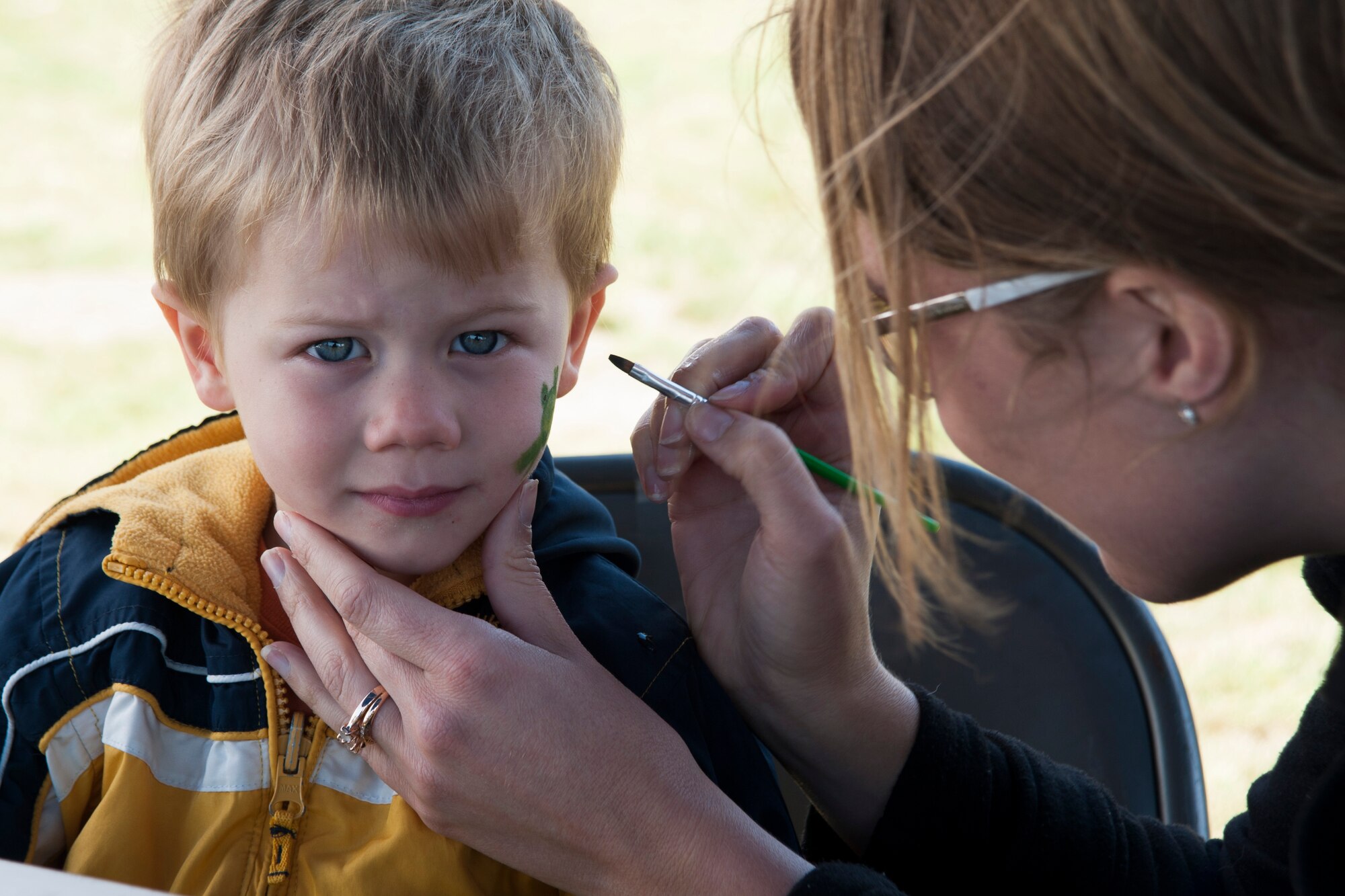 Tryston Bradley, son of Staff Sgt. Joshua Bradley, 30th Logistics Readiness Squadron vehicle mechanic, has his face painted during the 14th Annual Earth Day celebration April 23, 2014, Vandenberg Air Force Base, Calif. The 30th Civil Engineer Squadron hosted the event that showcased Vandenberg and the surrounding communities’ efforts to be “green.” (U.S. Air Force photo/ Airman 1st Class Yvonne Morales)