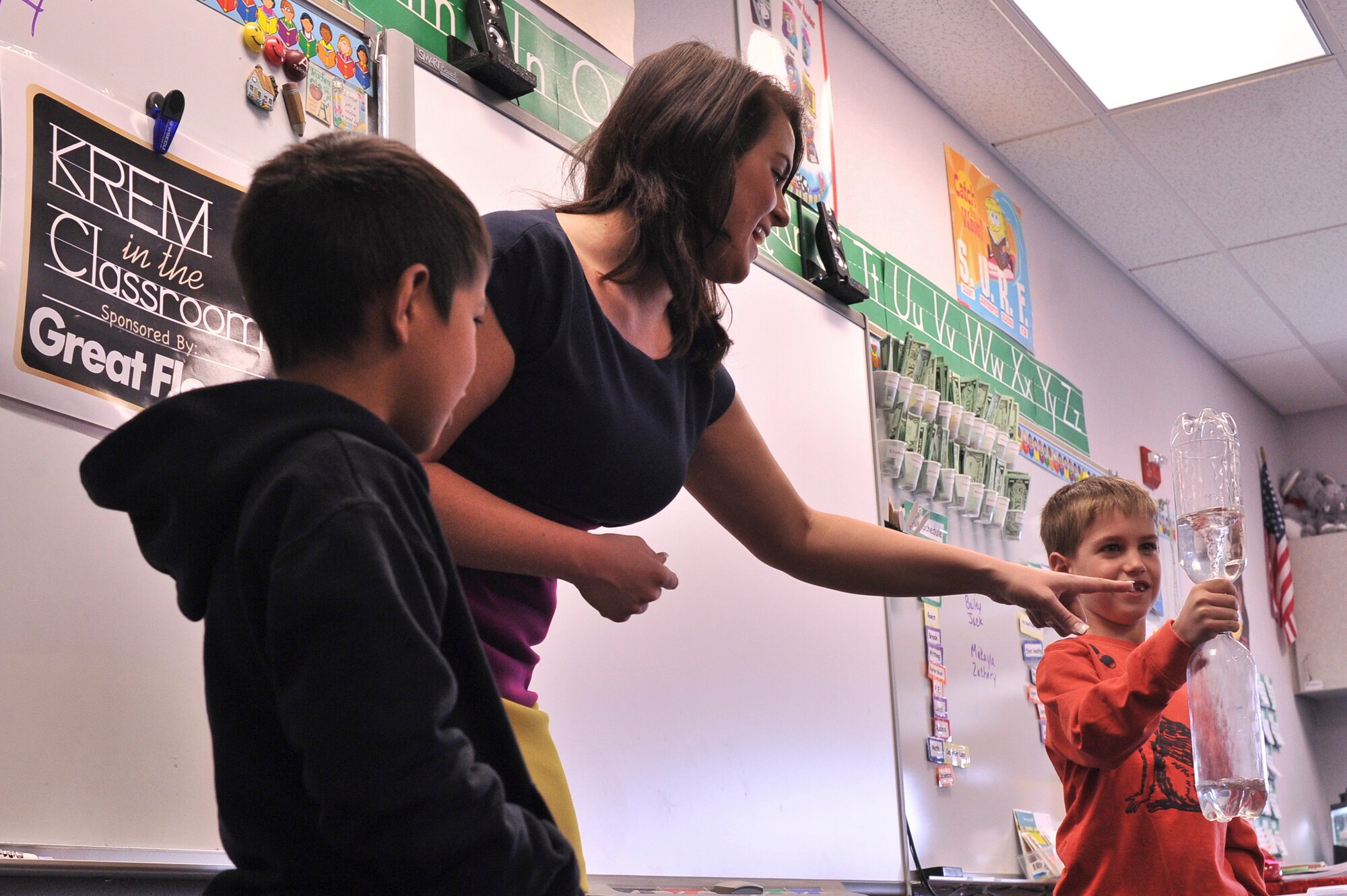 Children from Michael Anderson Elementary at Fairchild Air Force Base, Wash., help Katie Boer with an experiment to demonstrate how a tornado is formed April 21, 2014. Boer is a KREM 2 News weather anchor for the Inland Northwest Region. She visited Michael Anderson Elementary at Fairchild AFB to teach children the science of weather and the importance of following their dreams.  (U.S. Air Force photo by Staff Sgt. Alexandre Montes/Released)