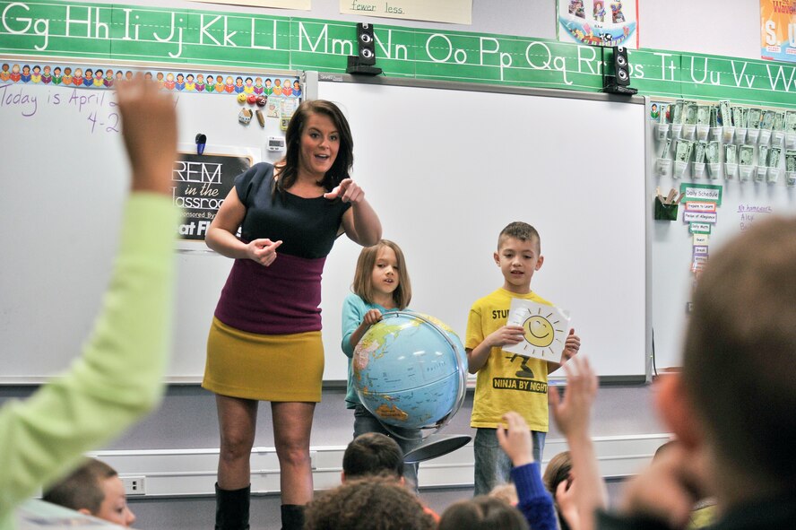Katie Boer calls on a student from Michael Anderson Elementary at Fairchild Air Force Base, Wash., to explain how the sun and earth rotation affects our weather April 21, 2014. Boer is a KREM 2 News weather anchor for the Inland Northwest Region. She visited Michael Anderson Elementary at Fairchild AFB to teach children the science of weather and the importance of following their dreams.  (U.S. Air Force photo by Staff Sgt. Alexandre Montes/Released)