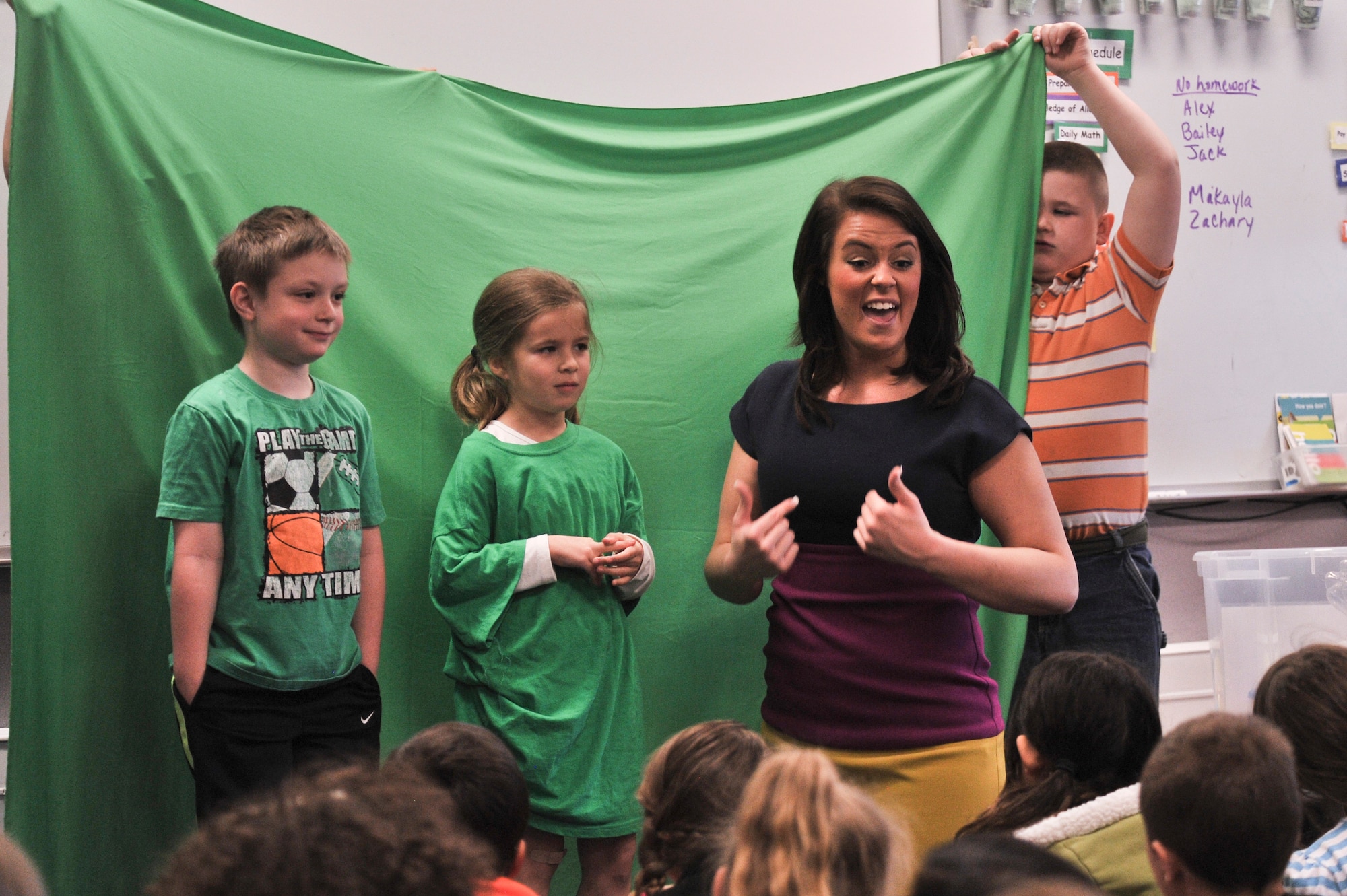 Children from Michael Anderson Elementary at Fairchild Air Force Base, Wash., help Katie Boer with an experiment to demonstrate how a green screen works for weather forecasting April 21, 2014. Boer is a KREM 2 News weather anchor for the Inland Northwest Region. She visited Michael Anderson Elementary at Fairchild AFB to teach children the science of weather and the importance of following their dreams.  (U.S. Air Force photo by Staff Sgt. Alexandre Montes/Released)