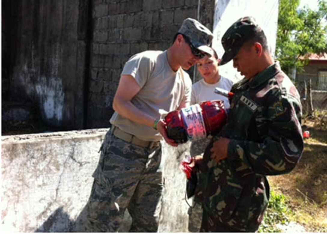 (Front left) Lt. Col. Patrick Hsieh, 926th Aerospace Medicine Squadron commander, prepares an Armed Forces of the Philippines soldier with a simulated impaled object to the chest and torso gunshot wounds during a training exercise March 28. Hsieh led the moulage team during the exercise. (photo courtesy of Guam Army National Guard public affairs)