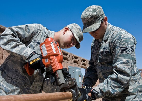 Airman 1st Class Joshua Buchanan and Senior Airman Nathan Lange, 99th Civil Engineer Squadron heating, ventilation and air conditioning technicians, press copper fittings for the distribution system of a new 20 ton chiller. According to the Energy.gov website, an air conditioners filters, coils and fins require regular maintenance for the unit to function efficiently throughout its years of service. Neglecting necessary maintenance ensures a steady decline in air conditioning performance while energy use steadily increases.