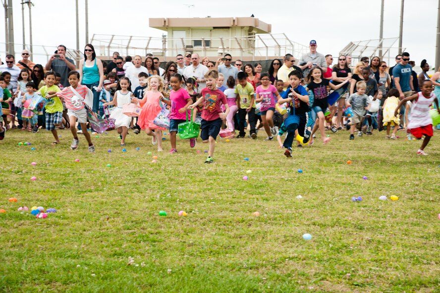 Children race to collect Easter eggs scattered on the Four Diamonds Softball Field on Kadena Air Base, Japan, April 19, 2014. The Eggsplosion, an annual event hosted by the Kadena Force Support Squadron, had egg hunts for different age groups, cultural demonstrations, food and prizes. Volunteers hid 50,000 eggs for the children to find. (U.S. Air Force photo by Staff Sgt. Alexy Saltekoff)