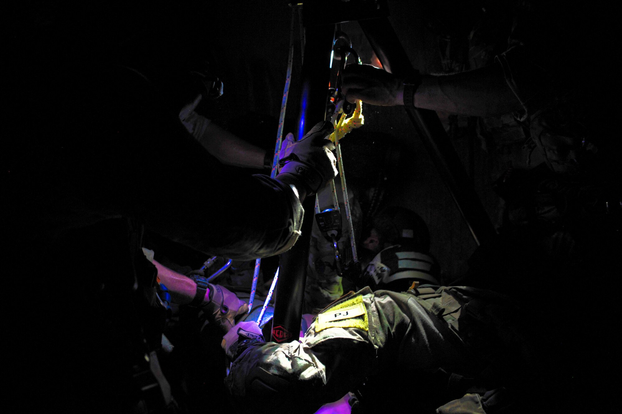 Pararescuemen from the 48th Rescue Squadron use a tripod rescue system to lower and extract casualties and rescuers during training at the Titan Missile Museum, Green Valley, Ariz., April 17, 2014.  The tripod is used to enter confined spaces when an overhead anchor is not available.  (U.S. Air Force Photo by Airman 1st Class Chris Massey/Released)