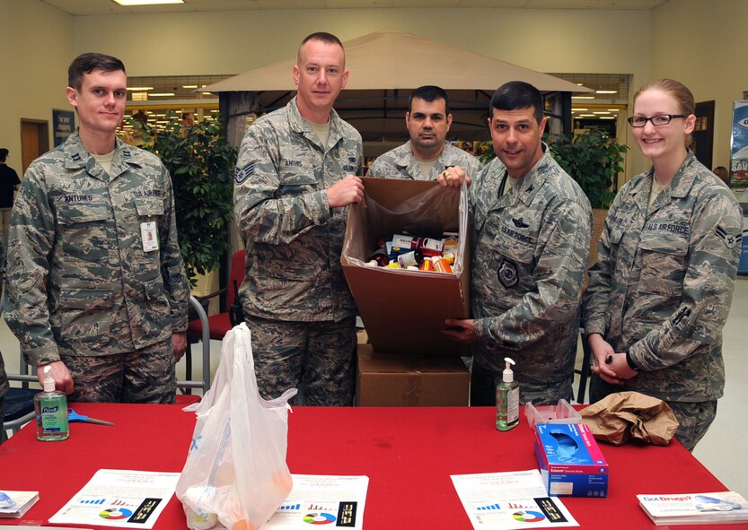 Col. Andrew Gebara, second from right, 2nd Bomb Wing commander, and members from the 2nd Medical Group and 2nd Security Forces Squadron pose for a photo during the nation-wide Prescription Drug Take-Back Day at the Exchange on Barksdale Air Force Base, La., April 23, 2014.This annual event is held twice a year. (U.S. Air Force photo/Staff Sgt. Sean Martin)
