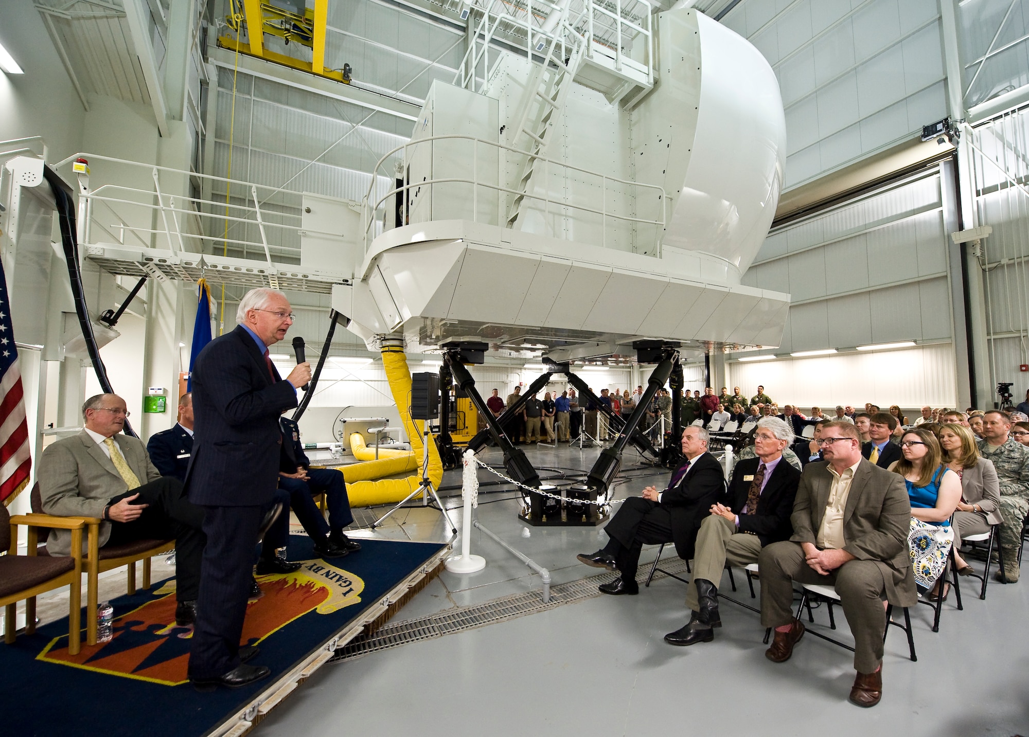 U.S. Rep. Randy Neugebauer speaks at the dedication ceremony for the new C-130J Super Hercules simulator April 22, 2014, at Dyess Air Force Base, Texas. Dyess is the first installation to receive this modern C-130J simulator with Vital-10 technology. Vital-10 is an advanced visual display package with a higher resolution and a more realistic display. System benefits include the ability to accomplish initial and recurring qualifications for missions, such as the Joint Precision Airdrop System and Heavyweight Assault Landings. (U.S. Air Force photo by Staff Sgt. Richard Ebensberger/Released)