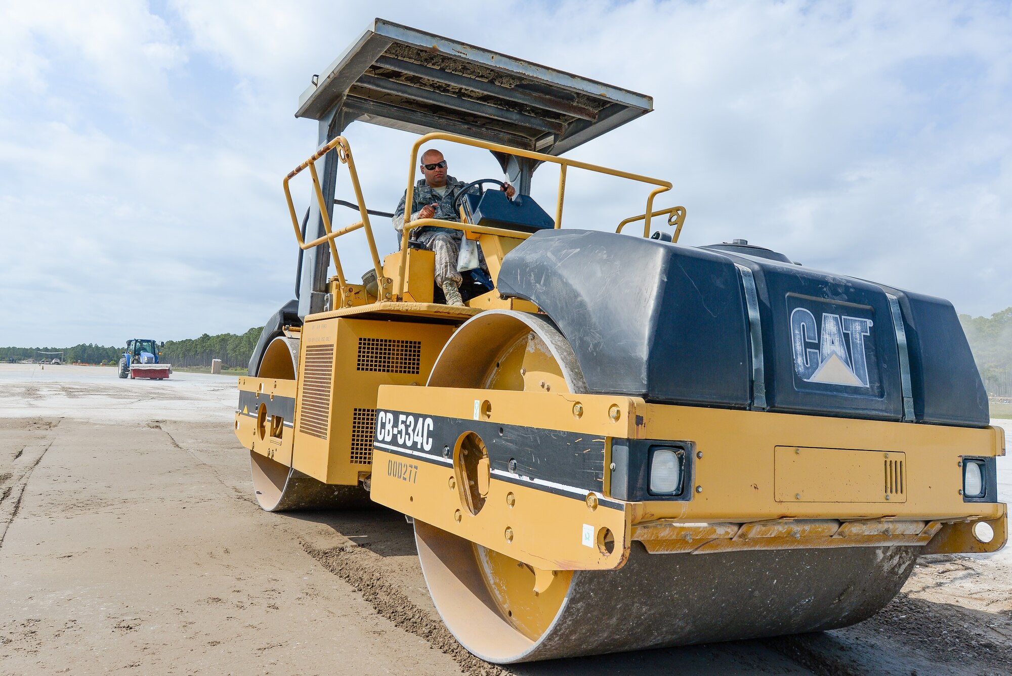 U.S. Air Force Senior Airman Abdel Rodriguez, a heavy equipment operator with the 116th Civil Engineering Squadron (CES), Georgia Air National Guard (ANG), Robins Air Force Base, Ga., drives a vibratory smooth drum roller while repairing a crater on the airfield at Silver Flag training at Tyndall Air Force Base, Fla., April 17, 2014. During the weeklong course, Guardsmen from the 116th CES along with 219 Airmen from multiple U.S. Air Force active duty, Reserve and Air National Guard units trained on building and maintaining bare-base operations at a simulated forward-deployed location. In addition, they honed their combat and survival skills, repaired simulated bomb-damaged runways, practiced EOD scenarios, set up base facilities and established various critical base operating support capabilities. Thirty-four Airmen from the 116th CES attended the exercise that consisted of extensive classroom and hands-on training culminating in an evaluation of learned skills on the last day of class. (U.S. Air National Guard photo by Master Sgt. Roger Parsons/Released)