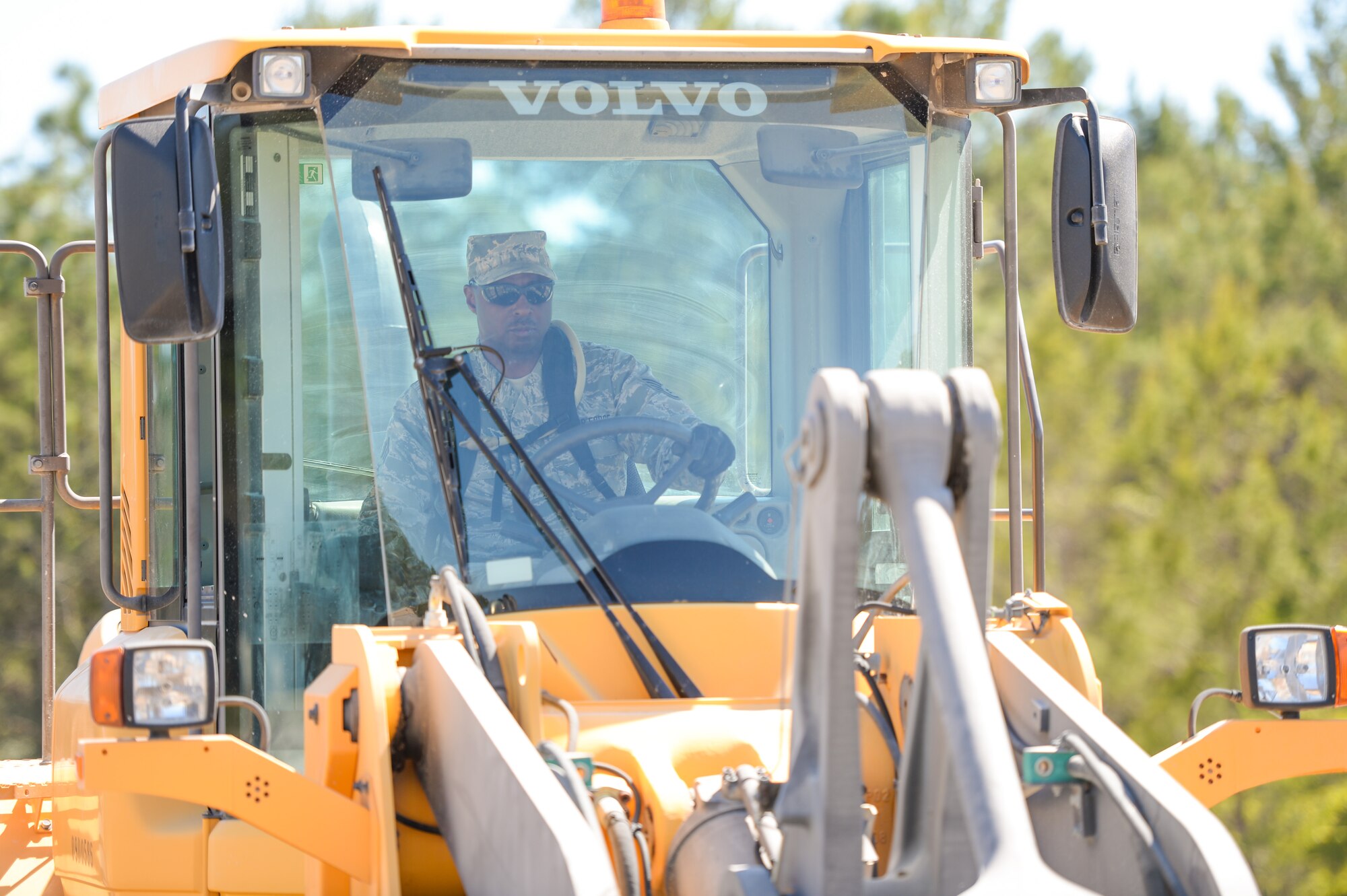 U.S. Air Force Staff Sgt. Marquette Davis, a heavy equipment operator with the 116th Civil Engineering Squadron (CES), Georgia Air National Guard, Robins Air Force Base, Ga., operates a front loader during Silver Flag training at Tyndall Air Force Base, Fla., April 16, 2014. During the weeklong course, Guardsmen from the 116th CES along with 219 Airmen from multiple U.S. Air Force active duty, Reserve and Air National Guard units trained on building and maintaining bare-base operations at a simulated forward-deployed location. In addition, they honed their combat and survival skills, repaired simulated bomb-damaged runways, set up base facilities and established various critical base operating support capabilities. Thirty-four Airmen from the 116th CES attended the exercise that consisted of extensive classroom and hands-on training culminating in an evaluation of learned skills on the last day of class. (U.S. Air National Guard photo by Master Sgt. Roger Parsons/Released)
