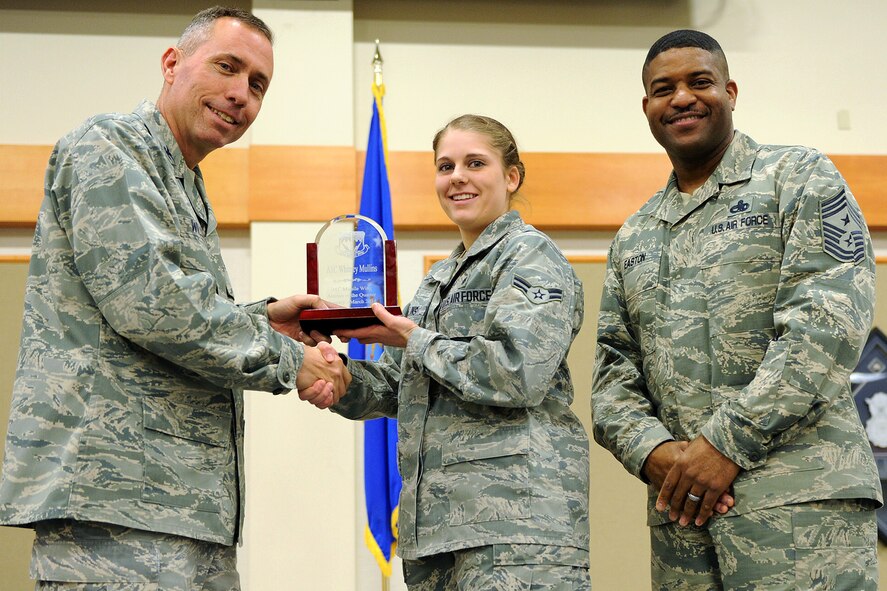 Airman 1st Class Whitney Mullins, 341st Medical Support Squadron, center, was named Malmstrom AFB's Airman of the Quarter for the first quarter of 2014.  Shown presenting the award are Col. John Wilcox, 341st Missile Wing commander, and Chief Master Sgt. Phillip Easton, 341 MW command chief.  The presentation was made at the Wing Quarterly Professional Awards ceremony held April 19 at the Grizzly Bend.  (U.S. Air Force photo/ Senior Airman Katrina Heikkinen)
