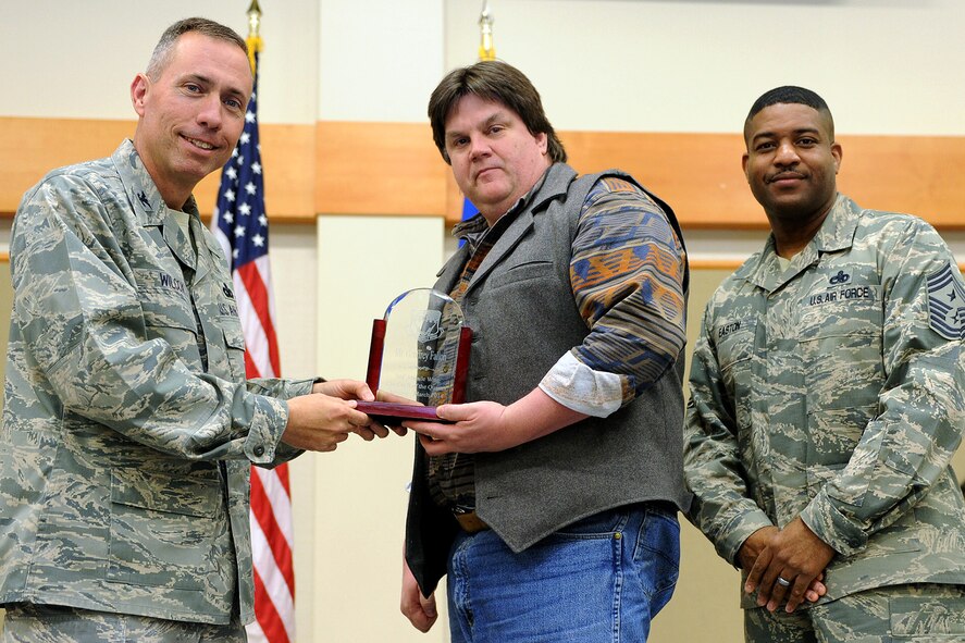 Geoffrey Fallon, 341st Medical Support Squadron, center, was named Malmstrom AFB's Non-Supervisor Category Two Civilian of the Quarter for the first quarter of 2014.  Shown presenting the award are Col. John Wilcox, 341st Missile Wing commander, and Chief Master Sgt. Phillip Easton, 341 MW command chief.  The presentation was made at the Wing Quarterly Professional Awards ceremony held April 19 at the Grizzly Bend.  (U.S. Air Force photo/ Senior Airman Katrina Heikkinen)