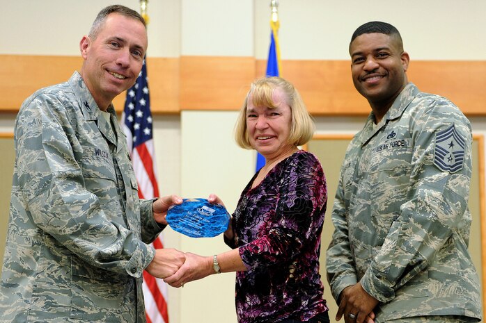 Eileen Gort, 341st Logistics Readiness Squadron, center, was named Malmstrom AFB's Civilian Volunteer of the Quarter for the first quarter of 2014.  Shown presenting the award are Col. John Wilcox, 341st Missile Wing commander, and Chief Master Sgt. Phillip Easton, 341 MW command chief.  The presentation was made at the Wing Quarterly Professional Awards ceremony held April 19 at the Grizzly Bend.  (U.S. Air Force photo/ Senior Airman Katrina Heikkinen)