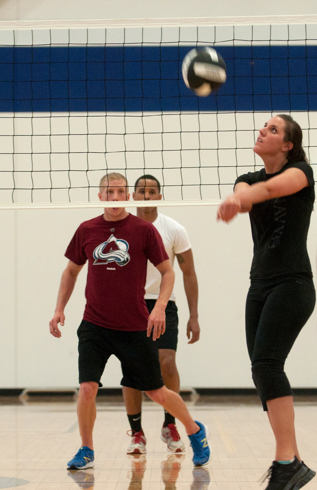 Katie Coble, 90th Missile Operations Squadron, hits a volleyball back to the opposing team April 21 during a volleyball match in the Freedom Hall Fitness Center. (U.S. Air Force photo by Airman Malcolm Mayfield)