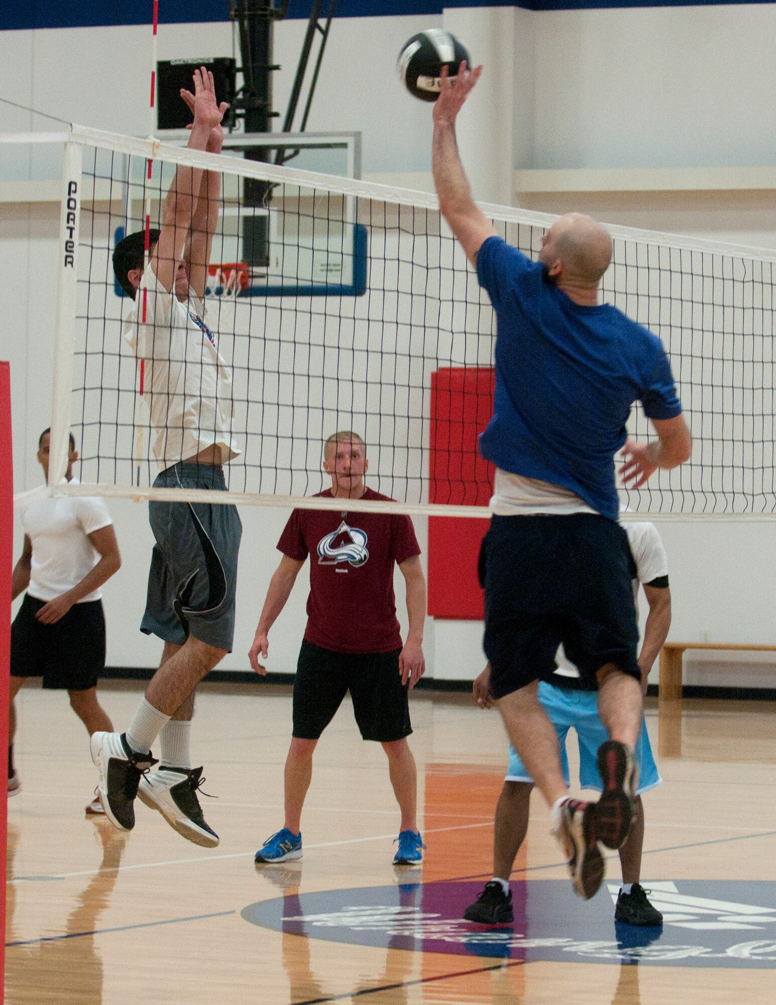 Carey Burgess, 90th Maintenance Group, sends a volleyball to the 30th Airlift squadron volleyball team during the final game of the 2014 Intramural Volleyball tournament April 21 in the Freedom Hall Fitness Center. The 30th Airlift Squadron beat the 90th MXG Volleyball team in the final game of the tournament 2 matches to 1.(U.S. Air Force photo by Airman Malcolm Mayfield)
