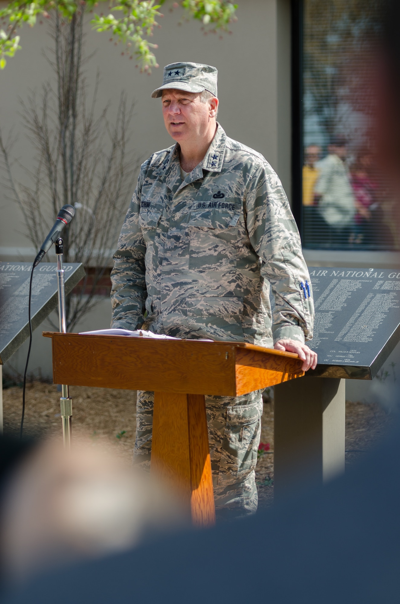 Maj. Gen. Edward Tonini, adjutant general of the Commonwealth of Kentucky, speaks to a crowd of more than 100 Airmen, friends and family during a ceremony honoring retirees at the Kentucky Air National Guard Base in Louisville, Ky., April 12, 2014. Two granite plaques, listing the names of Kentucky Air Guardsmen who retired in 2013, were unveiled during the ceremony. (U.S. Air National Guard photo by Airman 1st Class Joshua Horton)