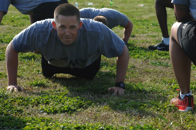 U.S. Army Staff Sgt. Dennis Botsch, 358th Transportation Detachment, 10th Trans. Battalion, 7th. Trans. Brigade (Expeditionary) transportation coordinator, performs push-ups during a group physical training portion of the Army Physical Readiness Training Leader Course at Fort Eustis, Va., April 22, 2014. The four-week course included hands-on training that incorporated basic military skills associated with PRT, such as marching, running, swimming, jumping, vaulting, climbing, carrying, lifting and load carrying. (U.S. Air Force photo by Senior Airman Teresa J.C. Aber/Released)