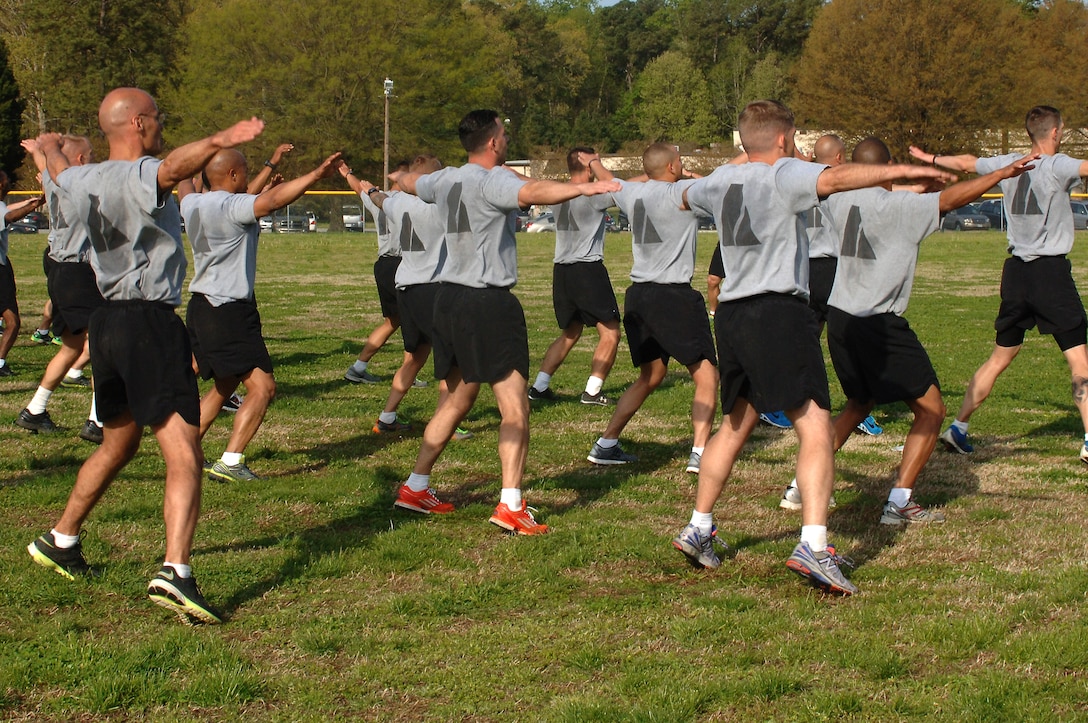 U.S. Army Soldiers perform half-jacks during a group physical training portion of the Army Physical Readiness Training Leader Course at Fort Eustis, Va., April 22, 2014. The course teaches Soldiers more about the new Physical Readiness Training program, a total body workout that incorporates traditional Army strength and endurance exercises, such as the eight-count pushup and the squat bender along with new drills such as the back bridge and medial leg raises. (U.S. Air Force photo by Senior Airman Teresa J.C. Aber/Released)