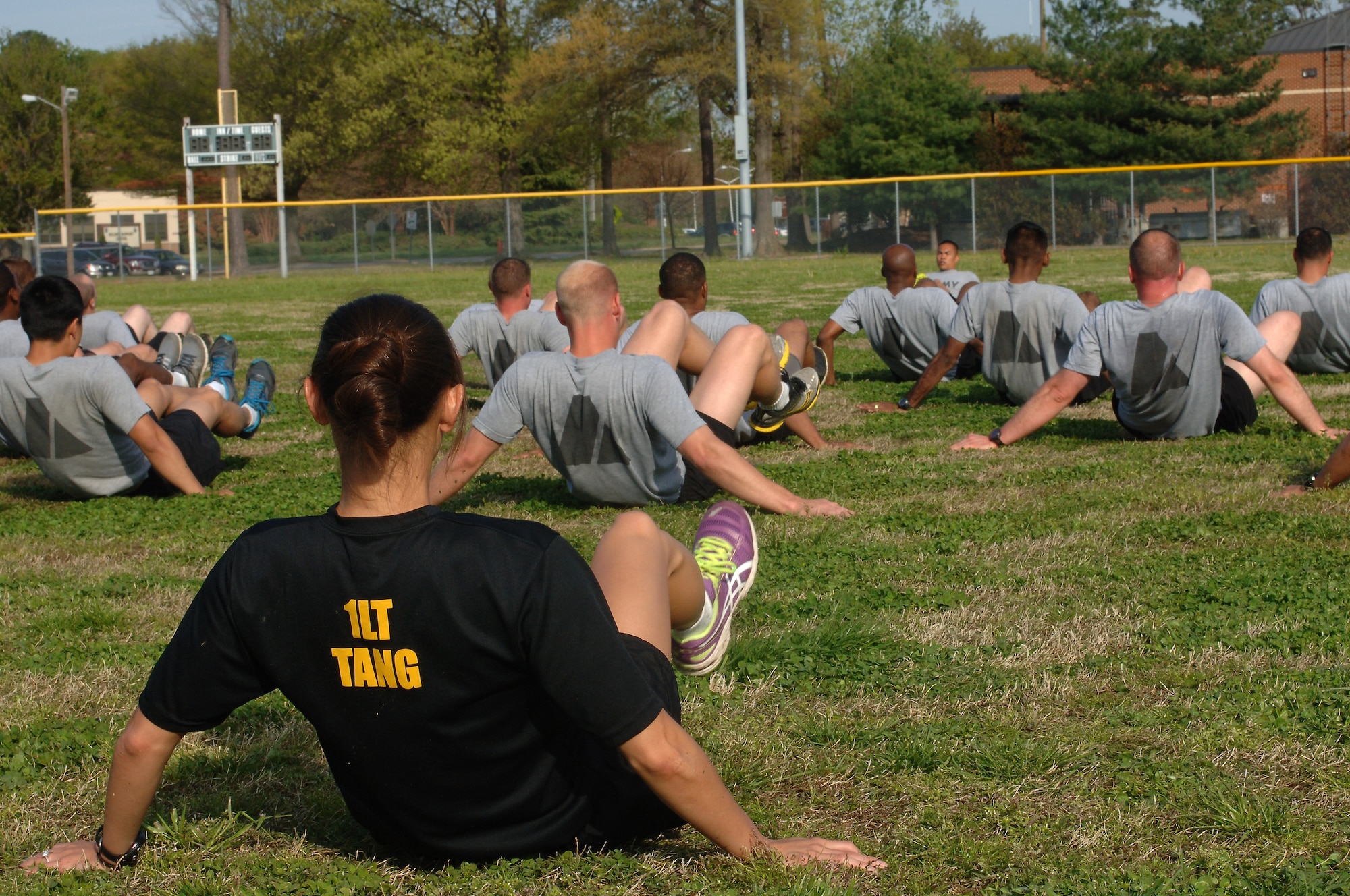 U.S. Army 1st Lt. Amy Tang, U.S. Army Physical Fitness School Mobile Training Team 6 leader, performs v-ups during a group physical training session at Fort Eustis, Va., April 22, 2014. Mobile training teams from the USAPFS travel to various installations to train drill sergeants, Advanced Individual Training platoon sergeants and other cadre to conduct PRT activities. (U.S. Air Force photo by Senior Airman Teresa J.C. Aber/Released)