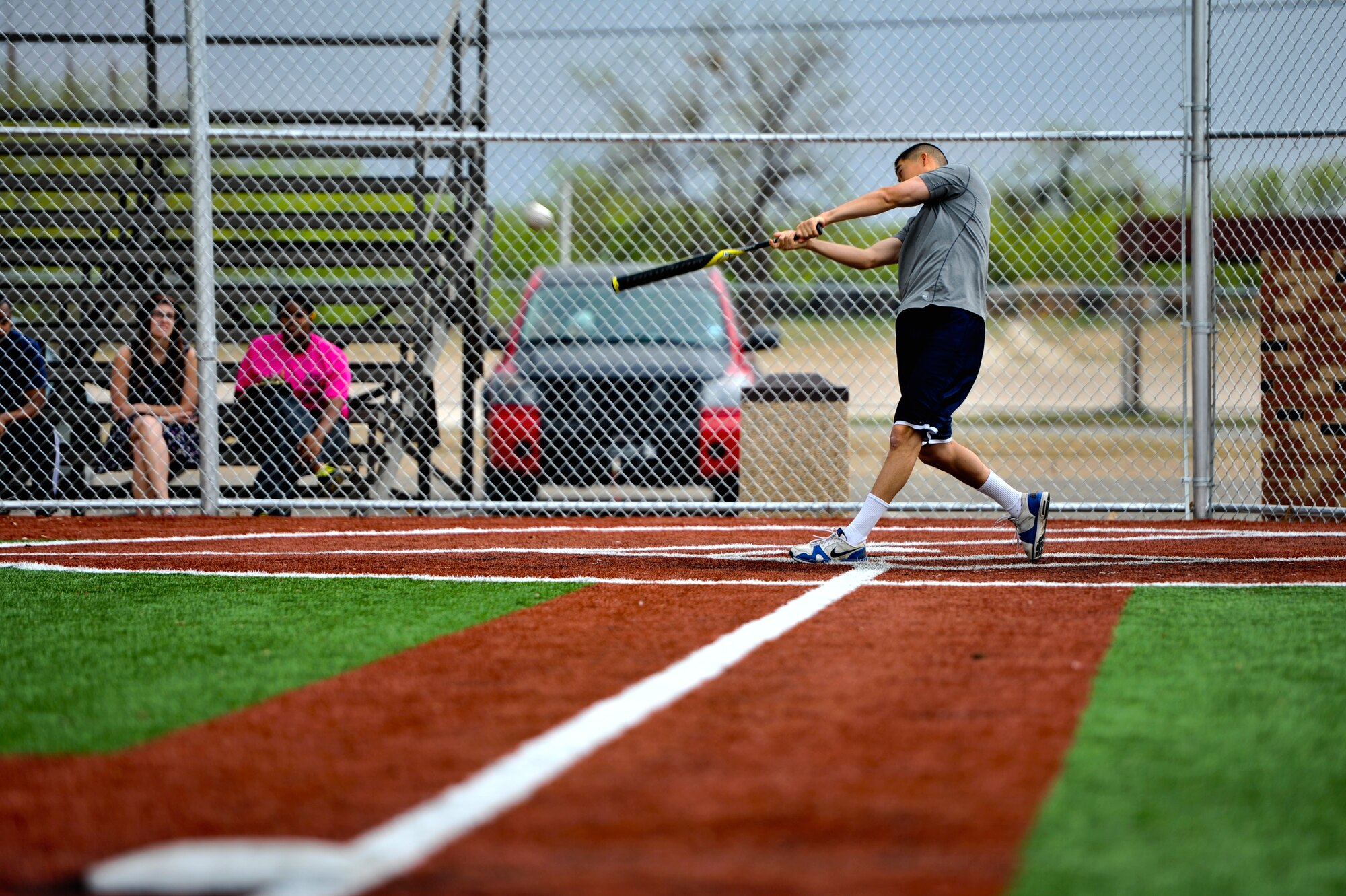 GOODFELLOW AIR FORCE BASE, Texas – U.S. Army Spc. Howard Kim, 344th Military Intelligence Battalion student, hits a softball at the Mathis Fitness Center’s multipurpose field during a home run derby here April 19. The player with the most home runs won a softball bat, a batting glove and a gift card. (U.S. Air Force photo/ Airman 1st Class Boyer)