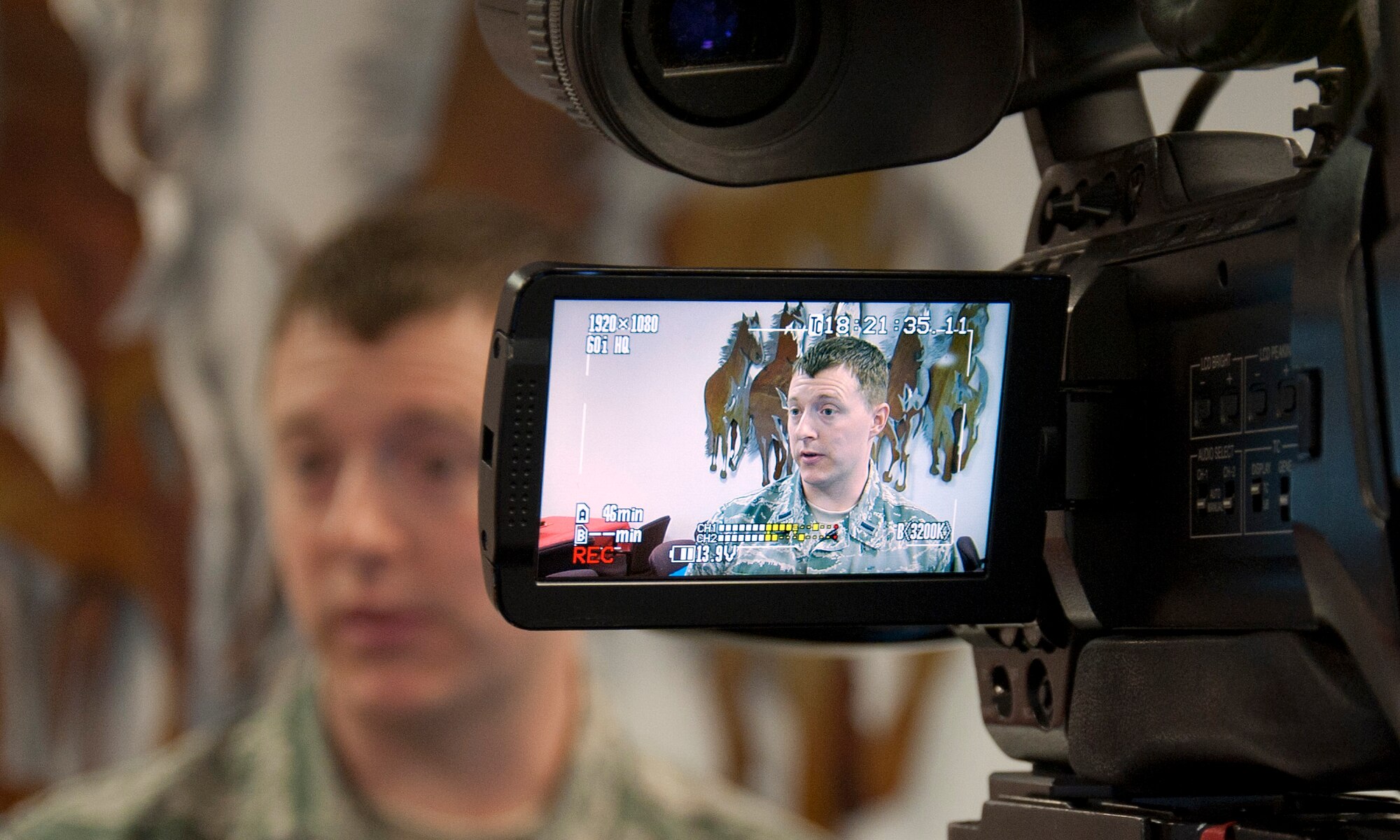140419-F-GZ967-045 First Lt. Paul Thrasher, 90th Force Support Squadron, speaks on camera about Retiree Appreciation Day during an interview with Bill Rentschler, a reporter with the local CBS 5 news channel KGWN, April 19 Day in the 90th Medical Group Medical Treatment Facility. “We want to make sure they know the base is here to support them, and we want to be there for them because of what they've done for us,” said Thrasher. (U.S Air Force photo by Airman 1st Class Brandon Valle)