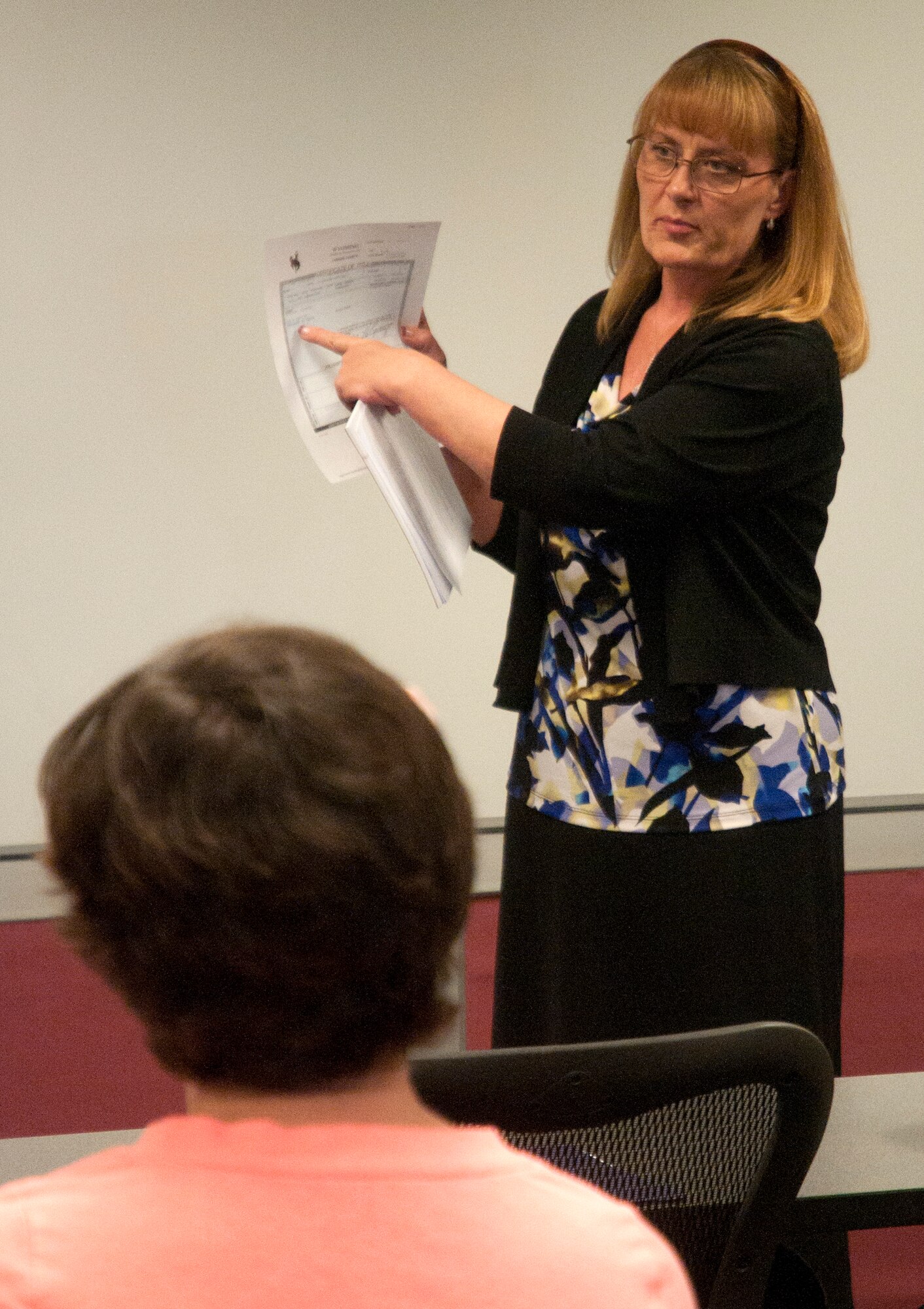 Cathie Tabor, office manager at Laramie County Abstract & Title Company, explains what title insurance is and how it can affect purchasing a home April 17 at a home buyer’s seminar in the Airman and Family Readiness Center. During the seminar, different methods of purchasing a home were discussed, along with how to find a realtor, what to watch out for when purchasing a home and what should be considered when spending money on a home. The next home buyer’s seminar is scheduled for October 17. (U.S. Air Force photo by Airman Malcolm Mayfield)
