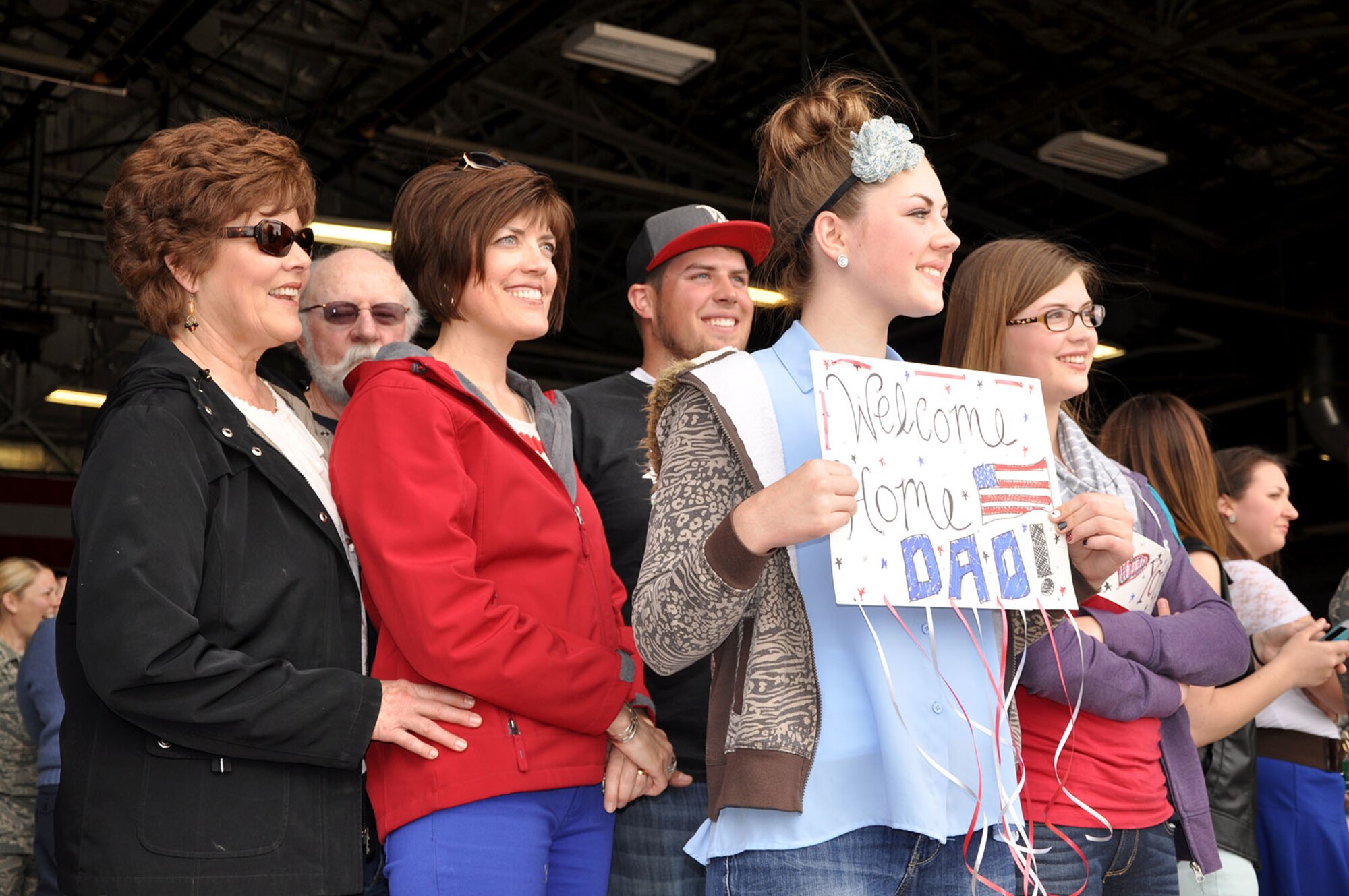 Tatum Troescher (front) and her family wait on the flightline for the arrival of Master Sgt. Bill Troescher, an Air Force reservist in the 419th Maintenance Group. Troescher, along with about 200 other Reserve and active-duty Airmen, returned home Tuesday after a four-month deployment to the Republic of Korea. (U.S. Air Force photo/Bryan Magaña)