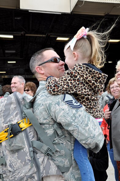 Master Sgt. Jason Moss, an Air Force reservist in the 419th Aircraft Maintenance Squadron, greets his daughter upon returning home from a four-month deployment to Osan Air Base, Republic of Korea. Moss was one of about 200 active-duty and Reserve Airmen who deployed as part of routine Theater Security Package rotation to the region. (U.S. Air Force photo/Bryan Magaña)