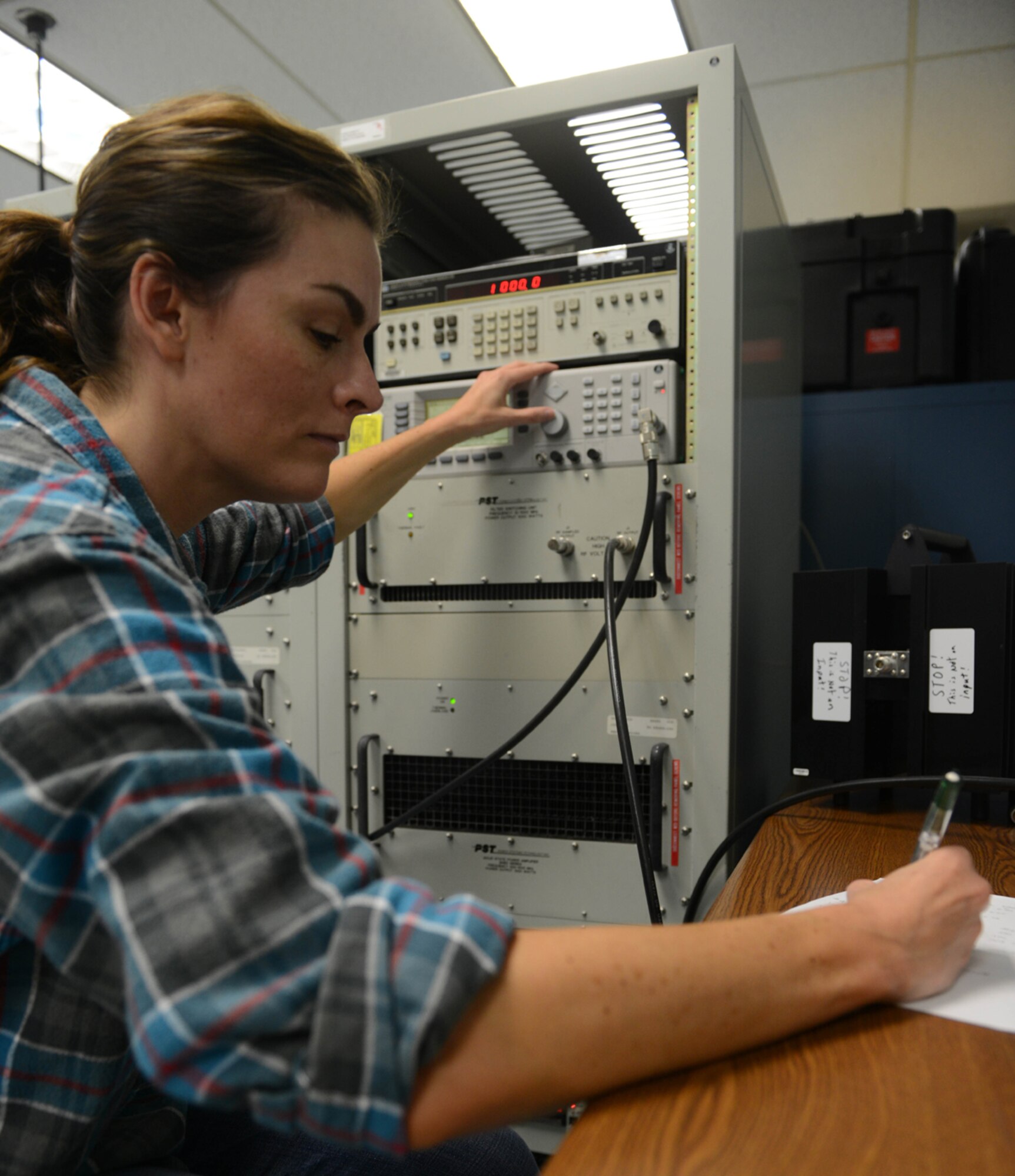 JOINT BASE ELMENDORF-RICHARDSON-- Elizabeth Maschmeyer, 3rd Maintenance Squadron Precision Maintenance Equipment Lab technician, records and calibrates wattsmeter readings at the PMEL on Joint Base Elmendorf-Richardson, Alaska, April 16, 2014. Customers the PMELs service as a whole have over 13,000 items requiring calibration and repair support. (U.S. Air Force photo/Airman 1st Class Ty-Rico Lea)