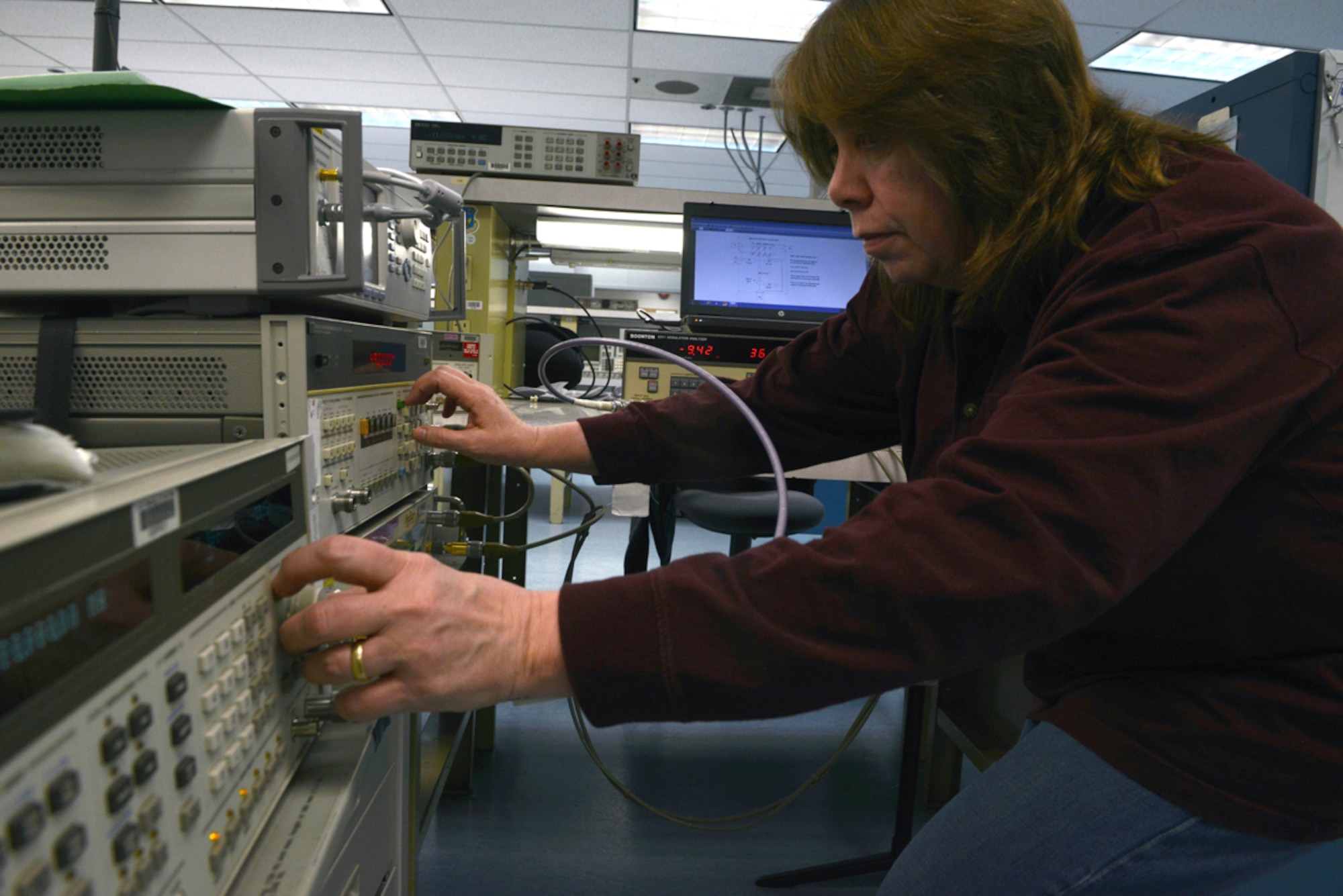 JOINT BASE ELMENDORF-RICHARDSON-- Carrie McMullen, 3rd Maintenace Squadron Precision Measurement Equipment Lab technician, calibrates a modulation analyzer at the PMEL on Joint Base Elmendorf-Richardson, Alaska, April 16, 2014. The PMEL applies Air Force and internationally recognized standards of measurement to various weapon, communication and support systems used throughout Alsak and the Pacific Air Forces command. (U.S. Air Force photo/Airman 1st Class Ty-Rico Lea)