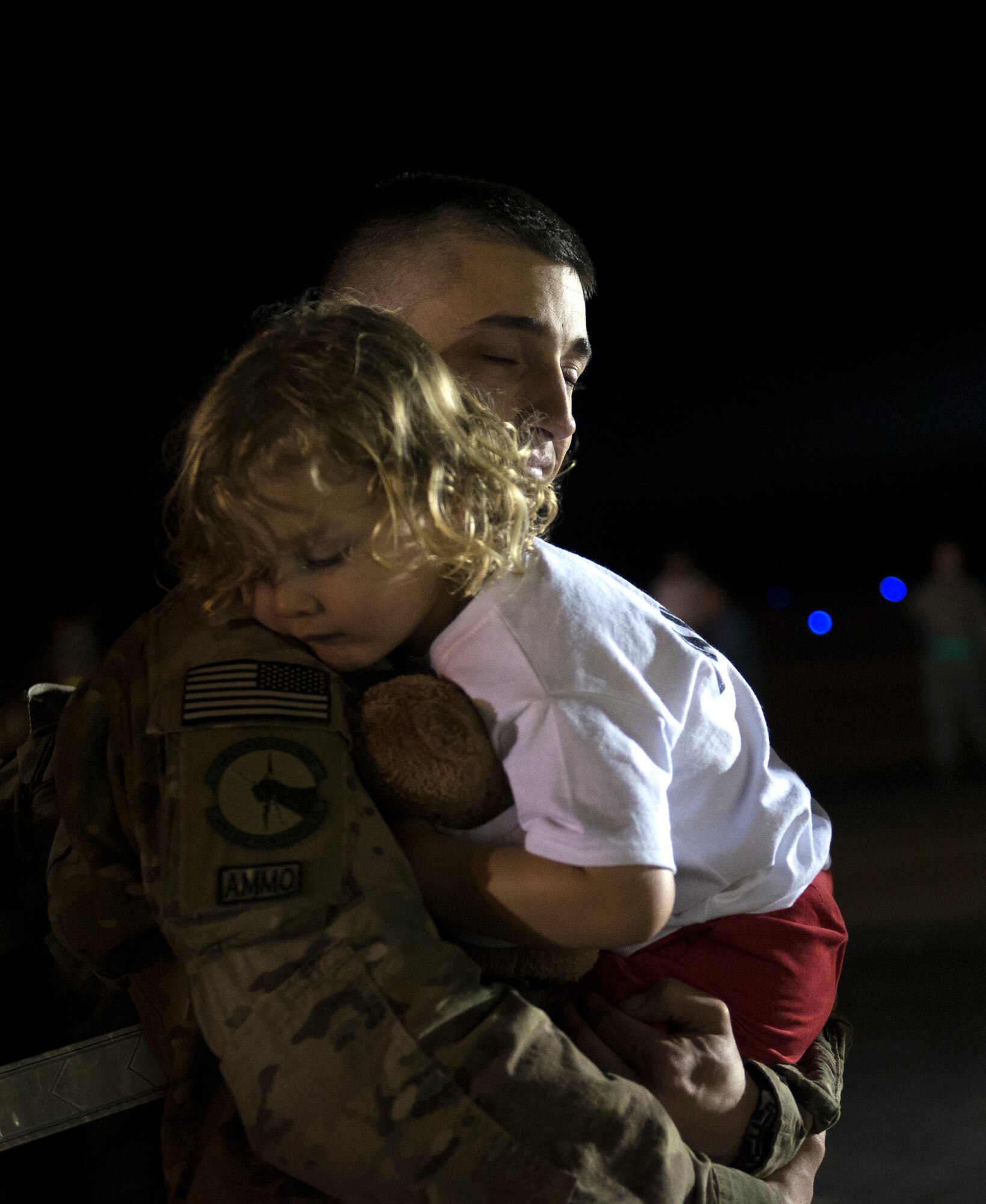 U.S. Air Force Tech. Sgt. Eric Ybarra, 23d Equipment Maintenance Squadron, holds his son during a deployment return at Moody Air Force Base, Ga., April 22, 2014. About 250 Airmen returned home from a six-month deployment to Bagram Airfield, Afghanistan. (U.S. Air Force photo by Senior Airman Jarrod Grammel/Released)

