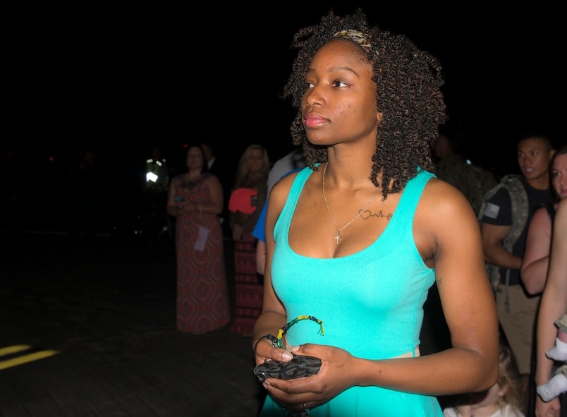 U.S. Air Force Senior Airman Olivia Bumpers waits for her husband, Senior Airman Jeremie Bumpers, to get off a plane during a deployment return at Moody Air Force Base, Ga., April 22, 2014. Olivia and Jeremie Bumpers celebrated their one-year anniversary while he was deployed to Bagram Airfield, Afghanistan. (U.S. Air Force photo by Senior Airman Jarrod Grammel/Released) 
